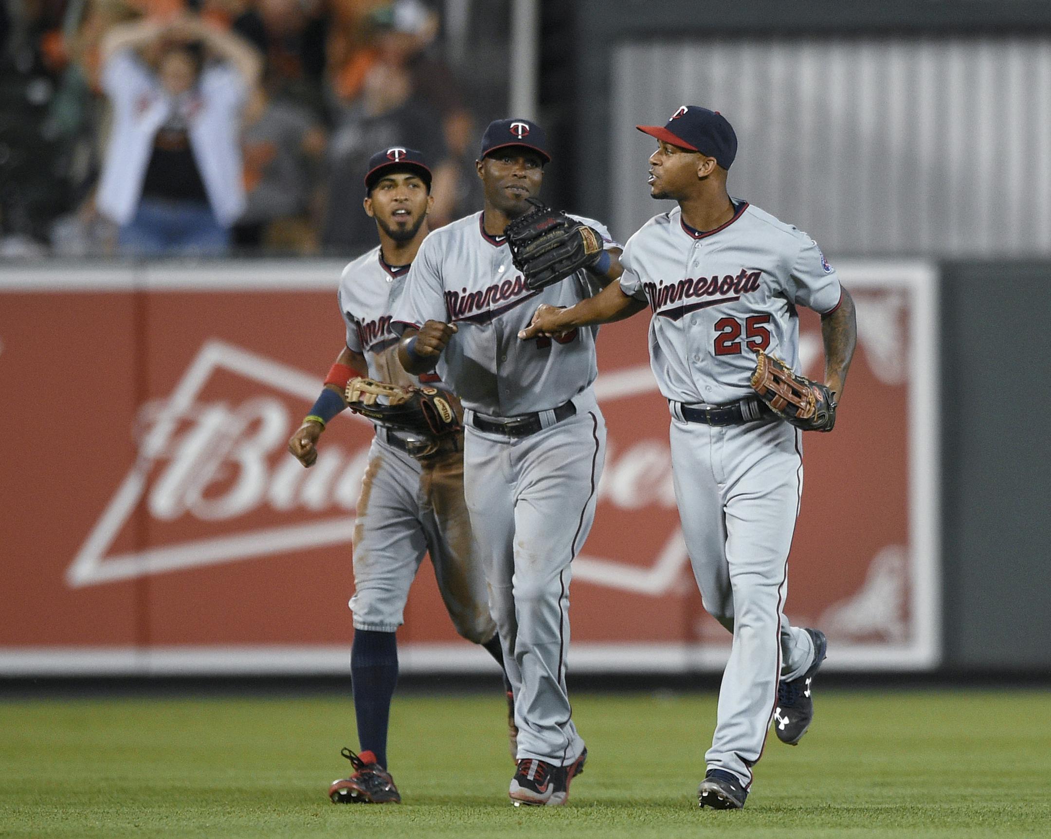 Minnesota Twins' Torii Hunter, center, Eddie Rosario, left, and Byron Buxton (25) celebrate a 3-2 win over the Baltimore Orioles in a baseball game, Saturday, Aug. 22, 2015, in Baltimore.
