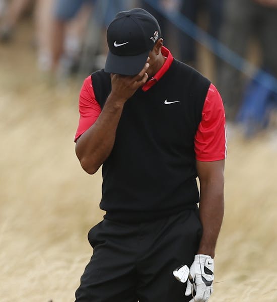 Tiger Woods of the United States reacts after playing a shot on the 11th hole during the final round of the British Open Golf Championship at Muirfiel