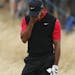 Tiger Woods of the United States reacts after playing a shot on the 11th hole during the final round of the British Open Golf Championship at Muirfiel