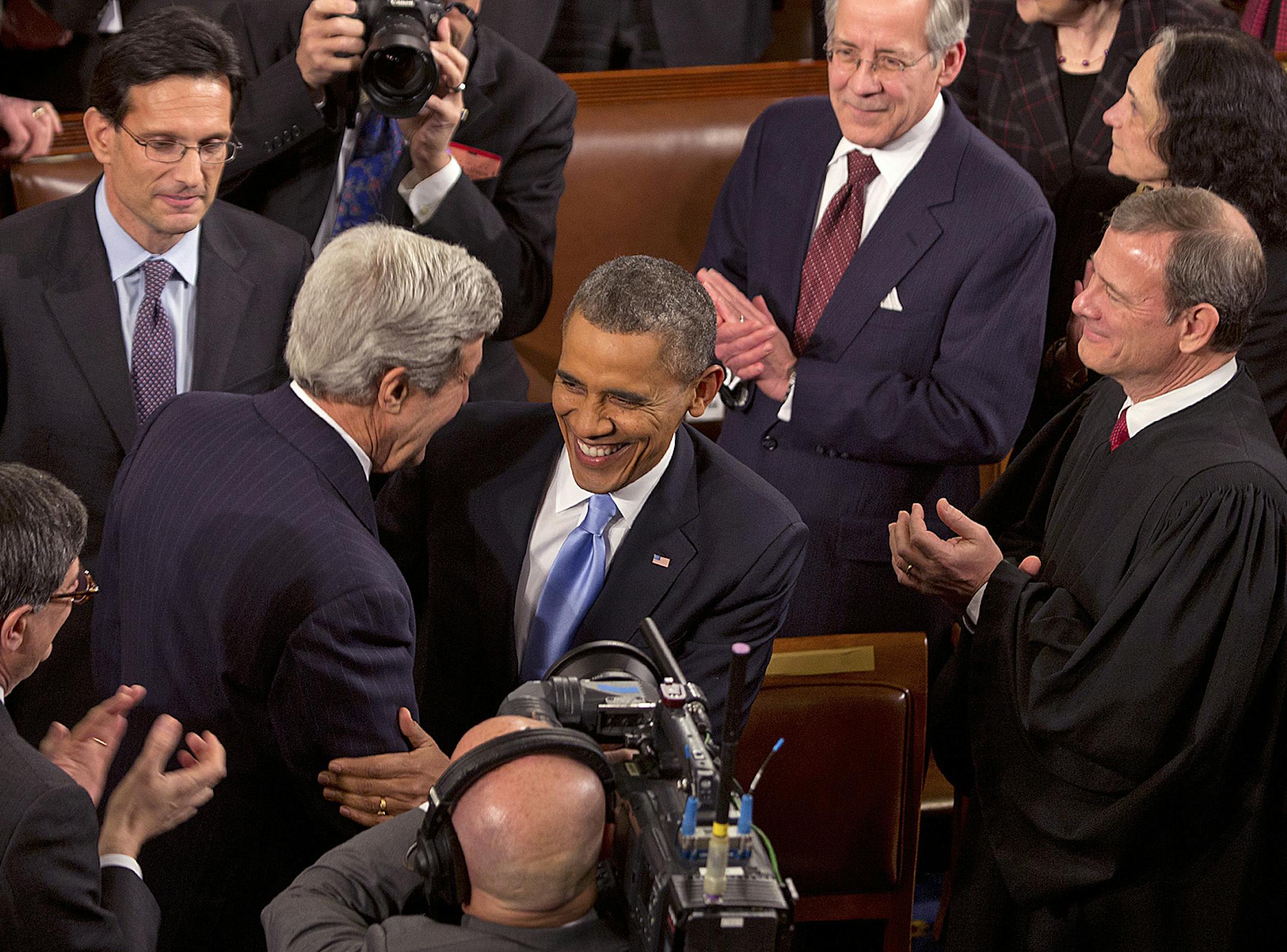 President Barack Obama embraces Secretary of State John Kerry after entering the House Chamber of the Capitol Building to deliver the State of the Union address, Jan. 28, 2014. From left: Rep. Eric Cantor, Kerry, Obama, Supreme Court Chief Justice John Roberts. (Stephen Crowley/The New York Times) ORG XMIT: MIN2014012821043209