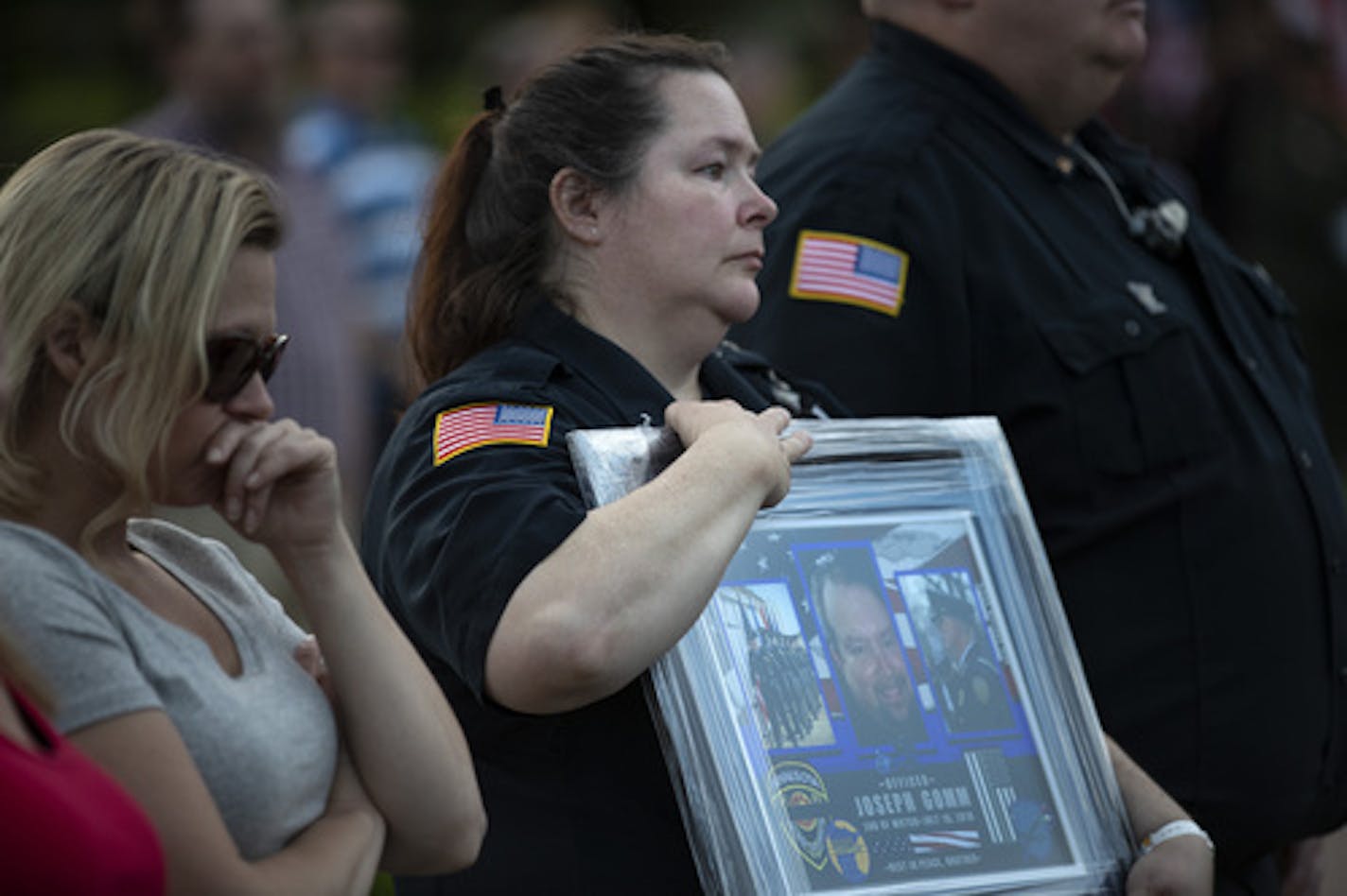 Dawn Willard a correction guard at Stillwater held a photograph of officer Joseph Gomm who was killed in 2018 at the Minnesota Law Enforcement Memorial Wednesday May 15, 2019 in St.Paul, MN. Willard worked 16 years with Gomm at Stillwater Prison .] Law Enforcement Memorial Day across the country, and the Minnesota Law Enforcement Memorial Association hosted a candlelight service at the Minnesota Law Enforcement Memorial. Jerry Holt • Jerry.holt@startribune.com