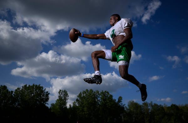 Running back Sawyer Seidl leaps for a portrait Tuesday, Aug. 23, 2022 at Hill-Murray High School in Maplewood, Minn.. Seidl is emerging as one of the 