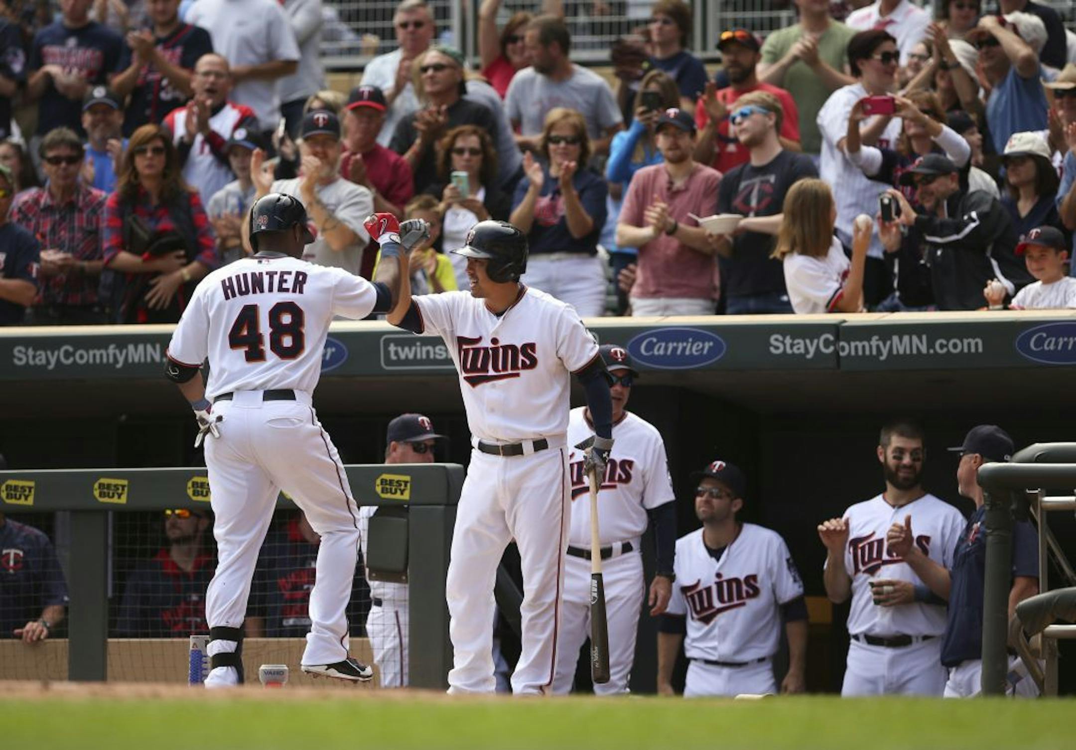 Twins right fielder Torii Hunter (48) was congratulated by Kurt Suzuki after his second inning home run Sunday afternoon at Target Field.