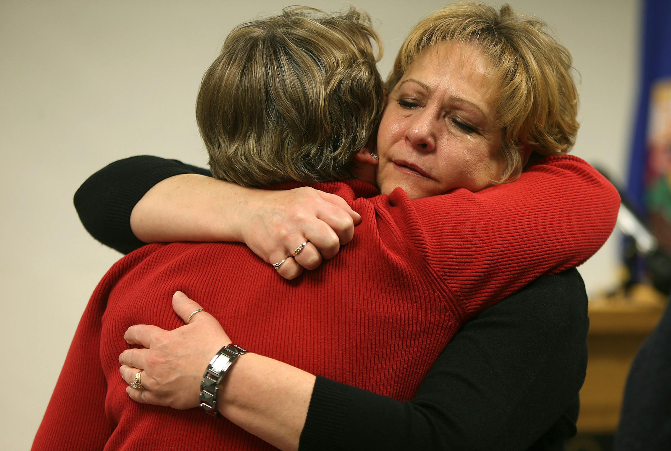 Claudia Jones, left, and Barbara Brown, the mother and step-mother of Margorie Ann Holland, hugged after a press conference, Tuesday, December 17, 2013 at the Dakota County Judicial Center in Hastings, MN. (ELIZABETH FLORES/STAR TRIBUNE) ELIZABETH FLORES • eflores@startribune.com