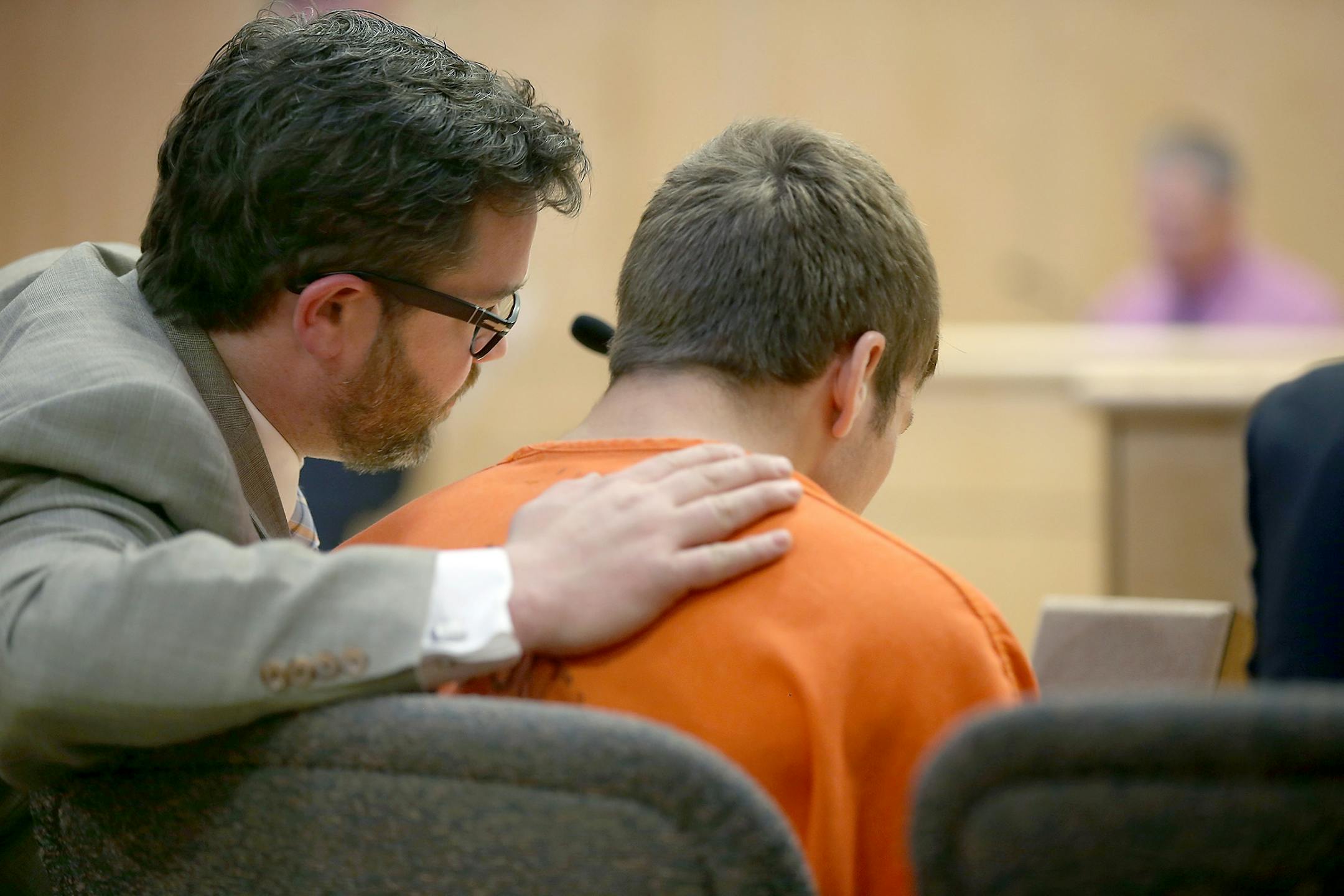 Defense Attorney Eric Nelson comforted 19-year-old Levi Acre-Kendall in the Polk County Justice Center, Wednesday, April 22, 2015 in Balsam Lake, WI.