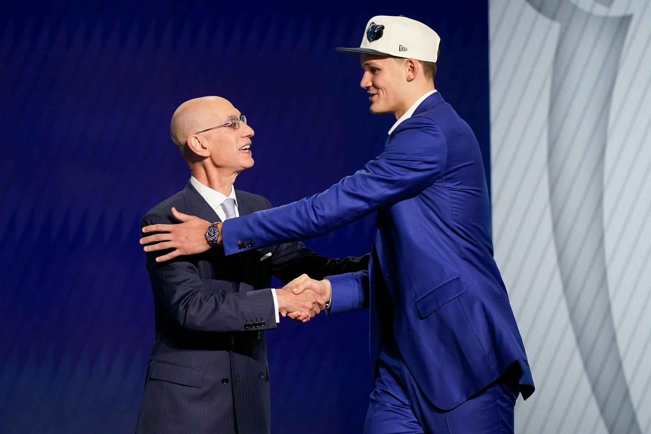 Walker Kessler, right is congratulated by NBA Commissioner Adam Silver after being selected 22nd overall by the Memphis Grizzlies in the NBA basketball draft, Thursday, June 23, 2022, in New York. (AP Photo/John Minchillo)