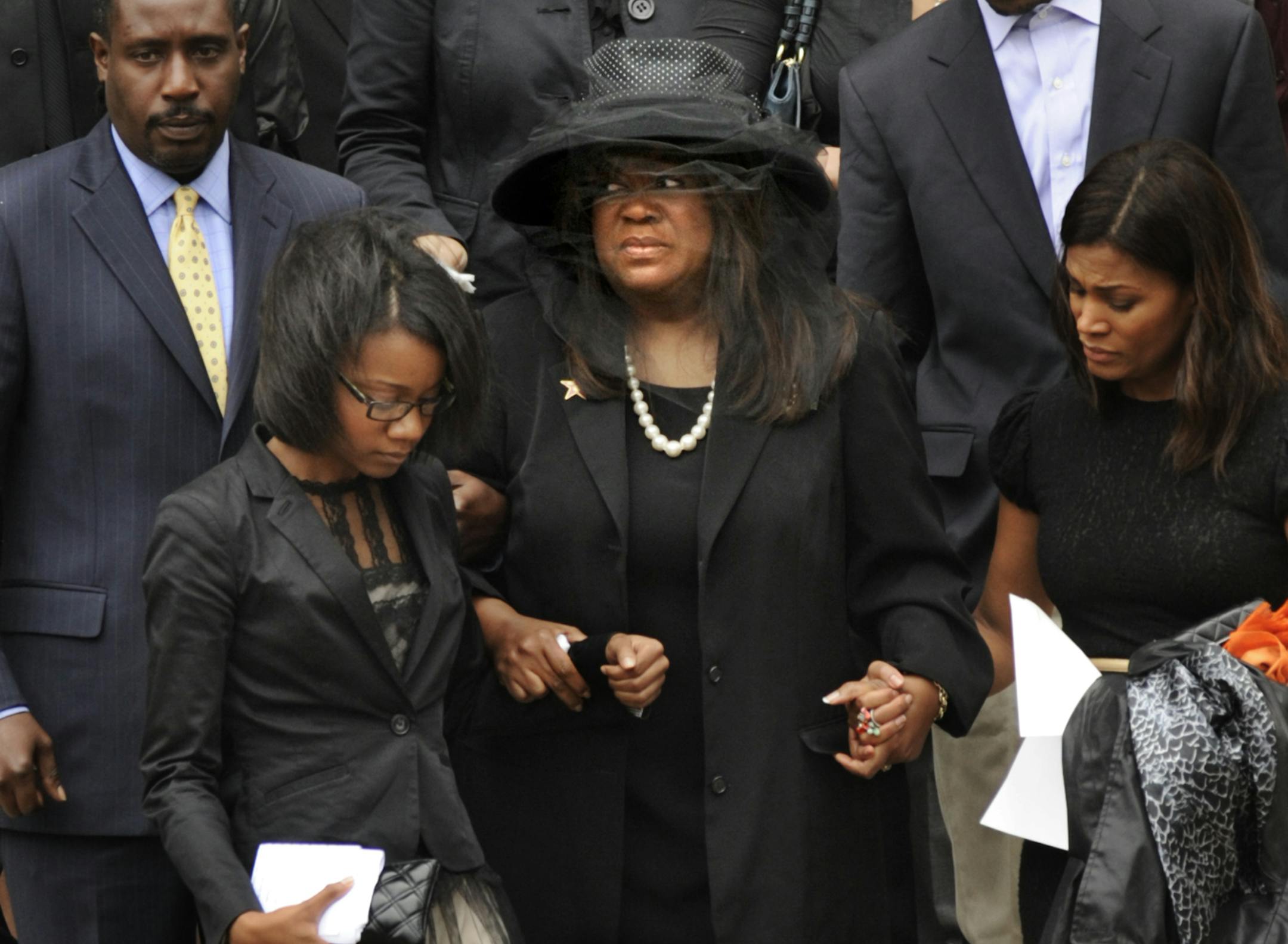 Chaz Ebert, center, wife of film critic Roger Ebert leaves Holy Name Cathedral after his funeral in Chicago, April 8, 2013. The Pulitzer Prize-winning movie reviewer died Thursday, April 4 at age 70 after a long battle with cancer. (AP Photo/Paul Beaty)