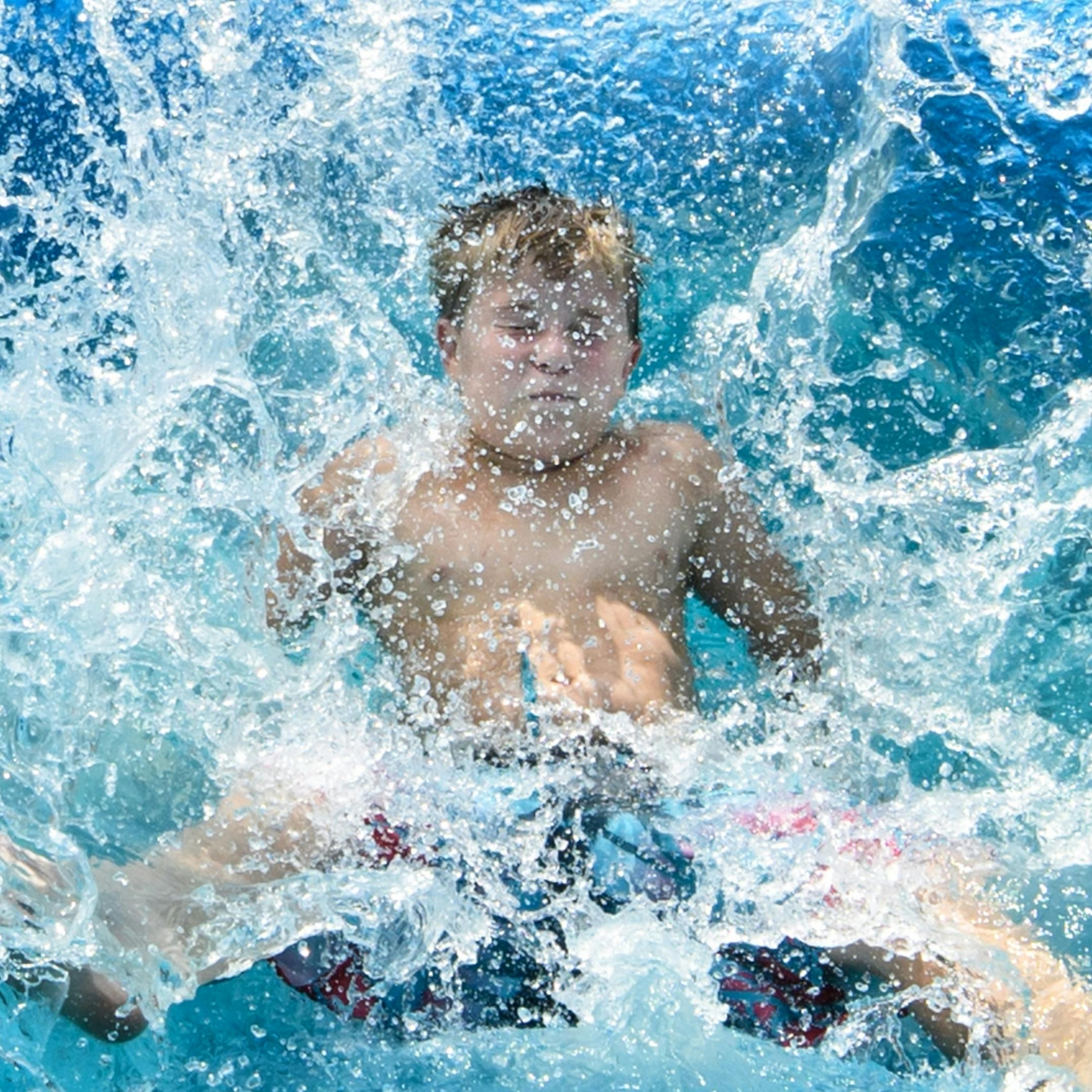 Grant Seager, 10. As temperatures soared close to 100 degrees, these 10-12 year-old soccer players cooled off at the water slide between games at Schwan's USA cup in Blaine.