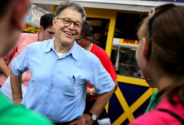 DFL Senator Al Franken handed out fans with his smiling image on them and greeted supporters in front of his booth Thursday morning at the first day o