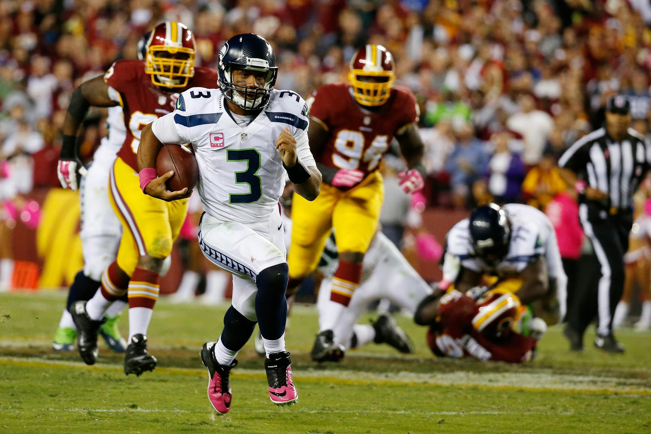 FILE - In this Oct. 6, 2014, file photo, Seattle Seahawks quarterback Russell Wilson (3) scrambles with the ball during the second half of an NFL football game against the Washington Redskins in Landover, Md. Wilson�s ability to get out of the pocket and run will always be part of what he brings to the position. (AP Photo/Alex Brandon, File)