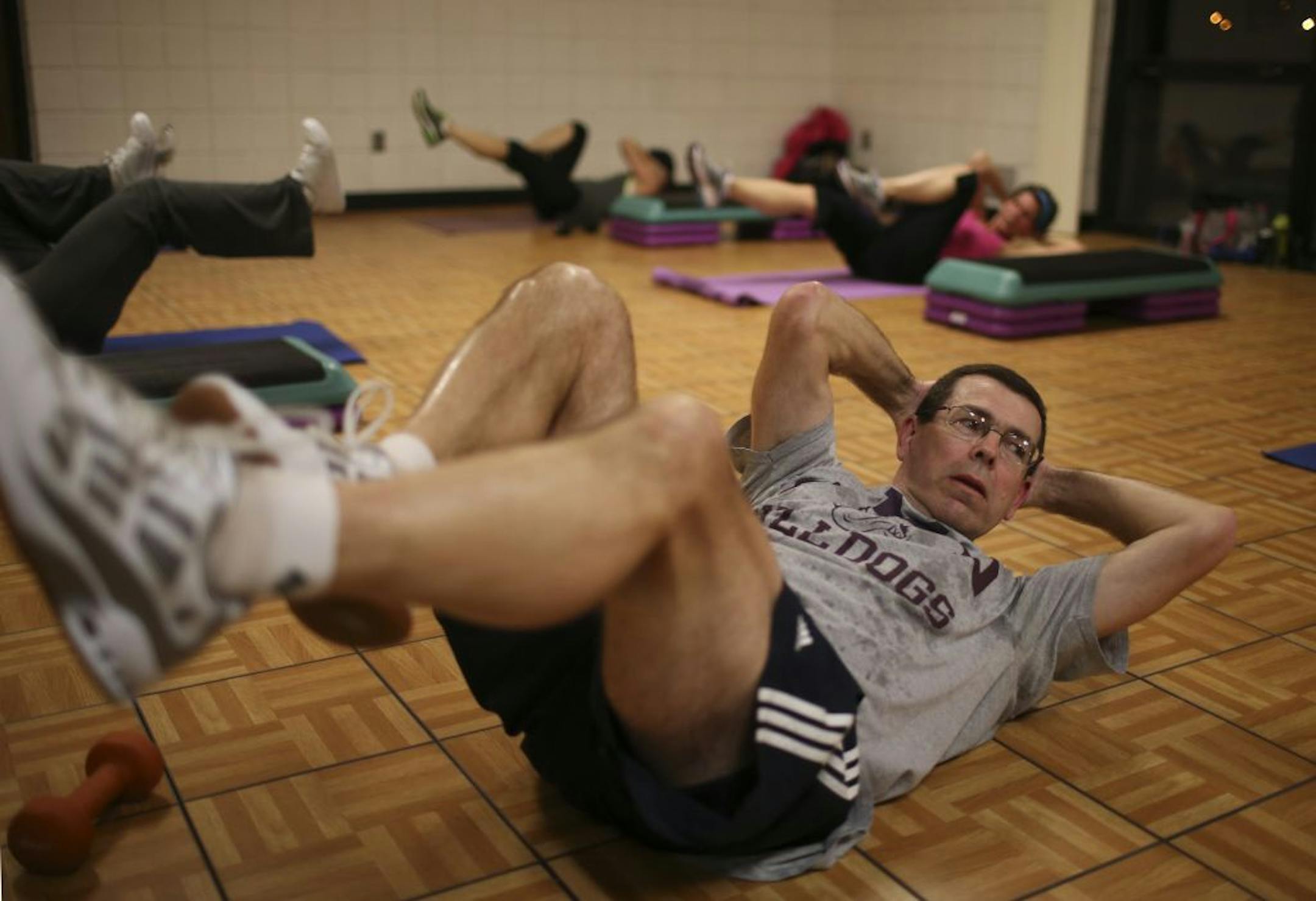 The Heart of New Ulm Project is a 10-year initiative aimed at preventing heart disease versus treating it after it occurs. The New Ulm City Recreation Center was busy on Wednesday, as it is every day, with yoga and aerobics classes and people walking on the track after work Thursday, February 7, 2013. John Russell worked out during Erin Ashby's Thursday evening step aeorbics class at the Recreation Center.