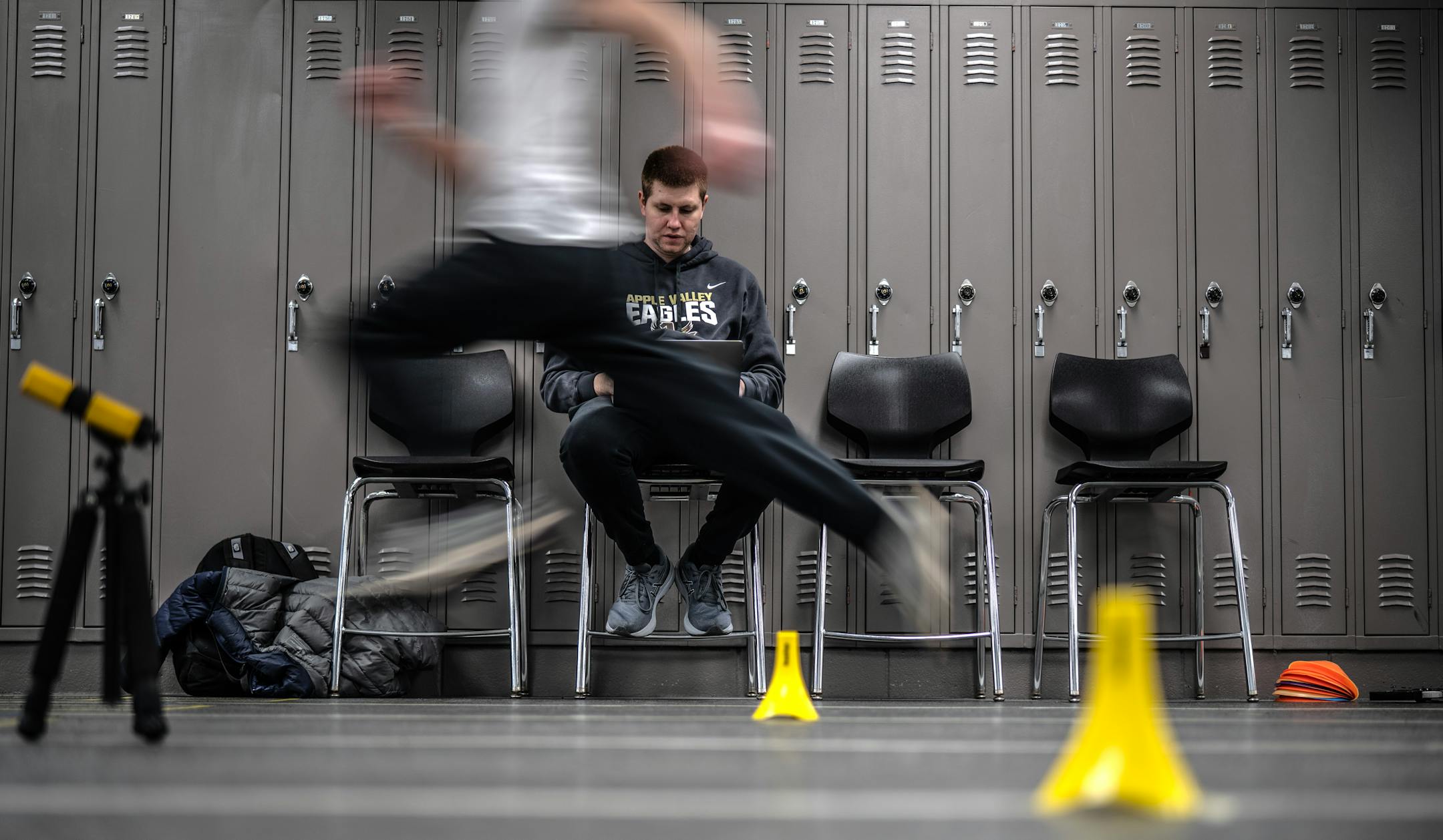 Apple Valley boys varsity track coach Zack Roble timed the players during morning practice in a school hallway.