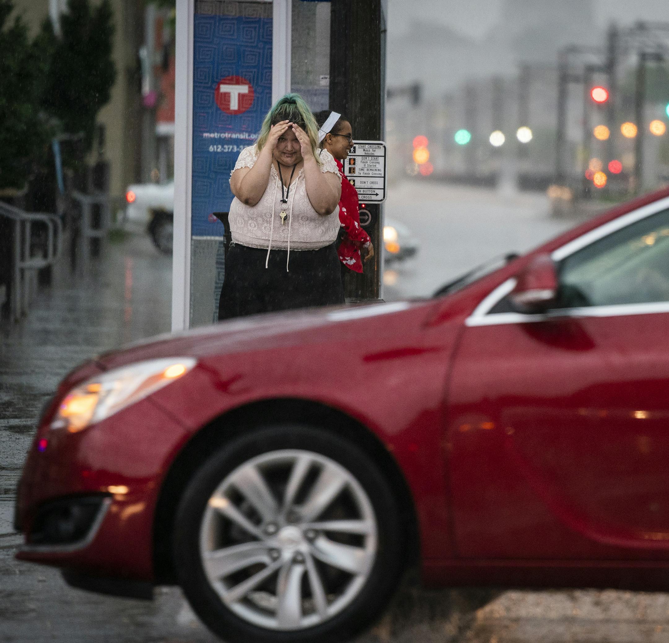 A pedestrian is caught in a storm at the corner of Dale Street and University Avenue. ] LEILA NAVIDI ¥ leila.navidi@startribune.com BACKGROUND INFORMATION: A thunderstorm rolls through St. Paul on Tuesday, June 4, 2019.