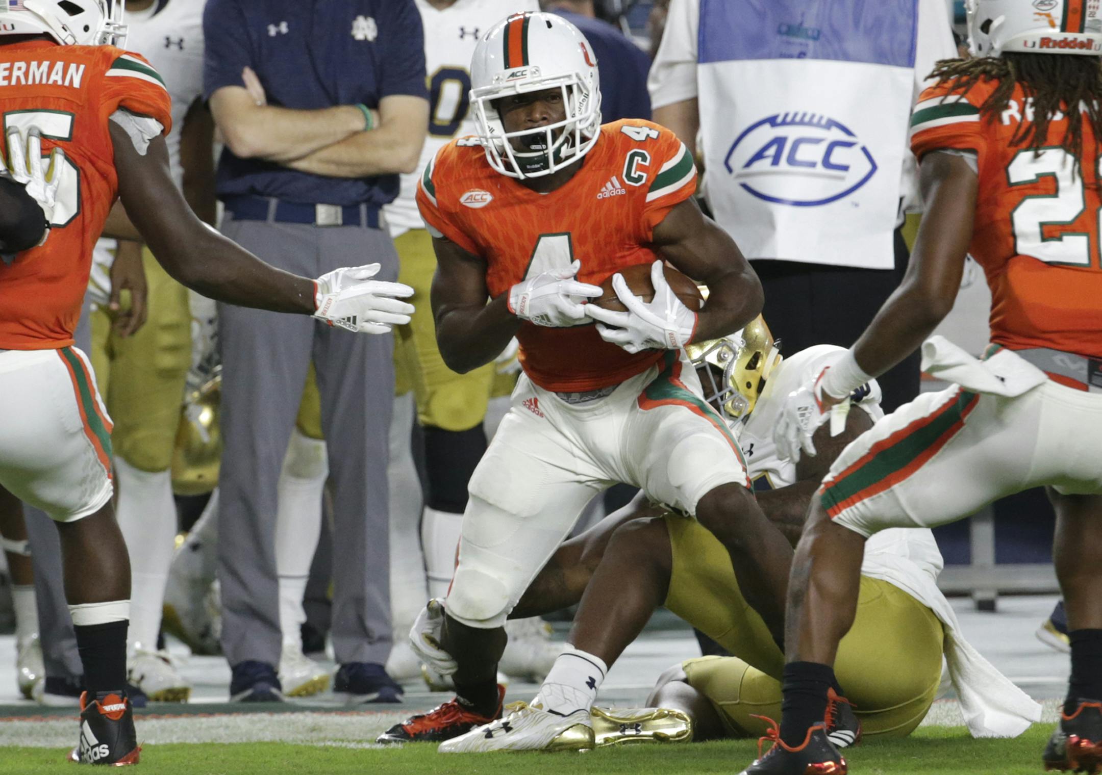 Miami defensive back Jaquan Johnson (4) runs after intercepting the football during the first half of an NCAA college football game against Notre Dame, Saturday, Nov. 11, 2017, in Miami Gardens, Fla. (AP Photo/Lynne Sladky)