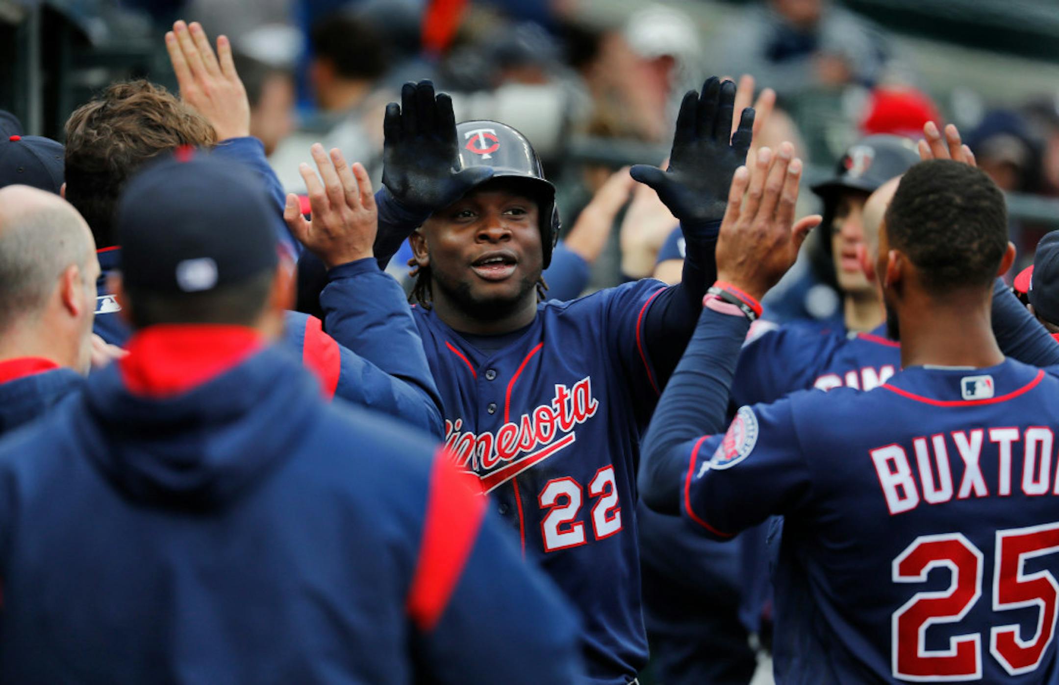 Miguel Sano celebrates his 440-foot home run to center field.