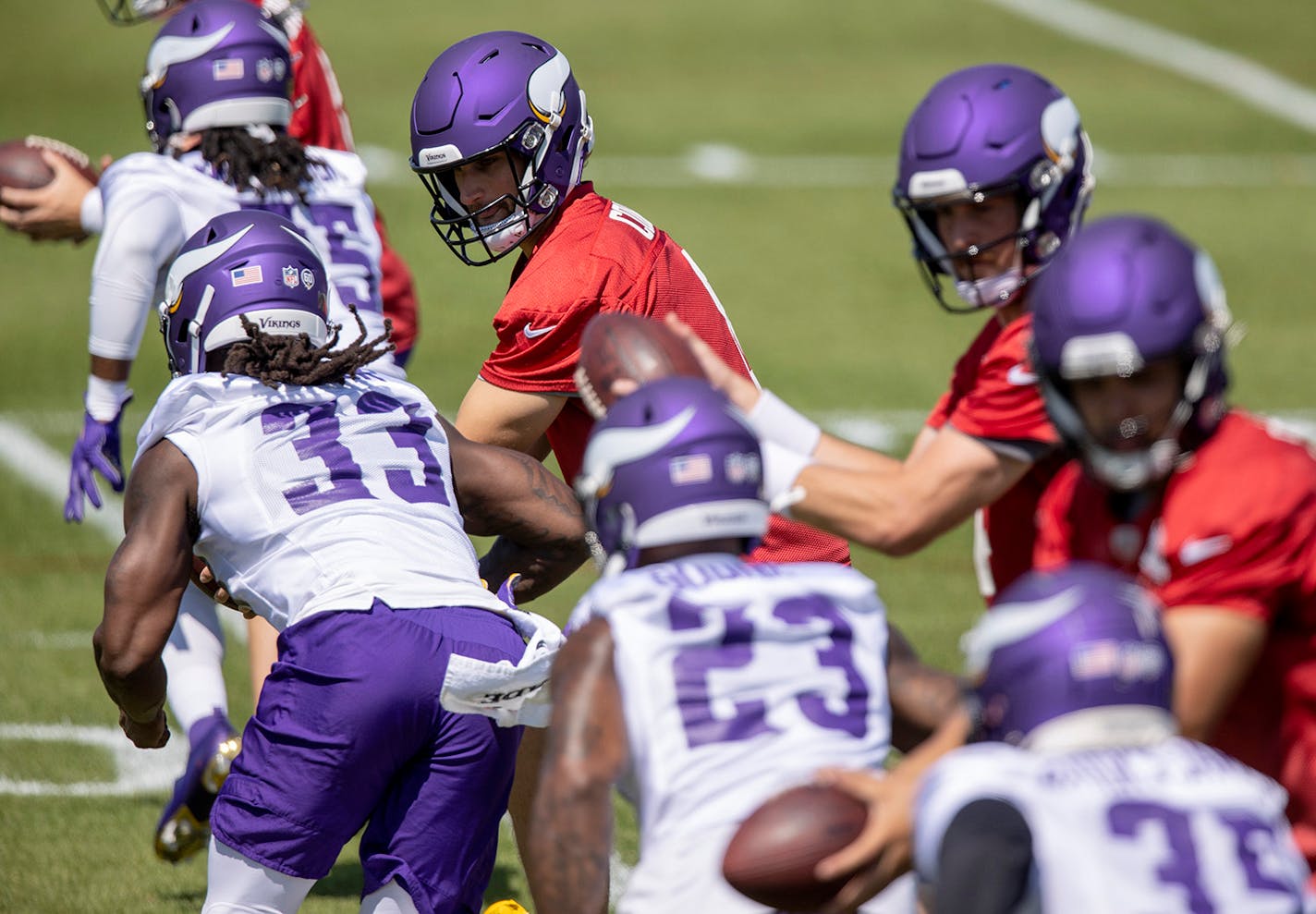 Vikings quarterbacks drilled on their handoffs with the running backs, including Kirk Cousins (8) giving the ball Dalvin Cook (33), during Sunday's practice.