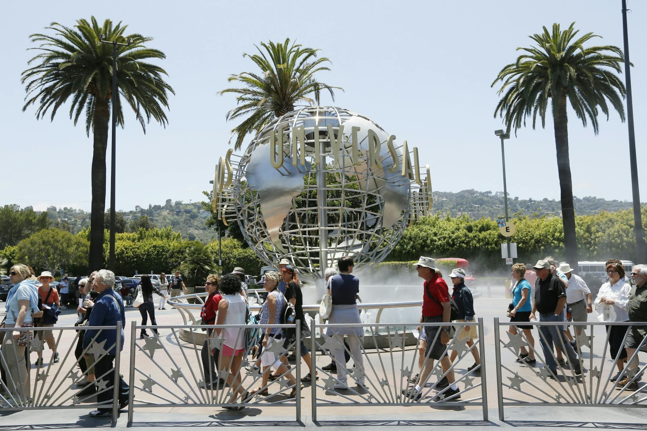 This photo taken Wednesday, June 5, 2013, show tourists lining up at the normal line at Universal Studios Hollywood in Los Angeles. Many theme parks now have VIP tours with perks usually reserved for celebrities _ private tour guides, no waits for the biggest attractions, reserved seating at shows and parades along with behind-the-scenes peaks at places normally off limits.
