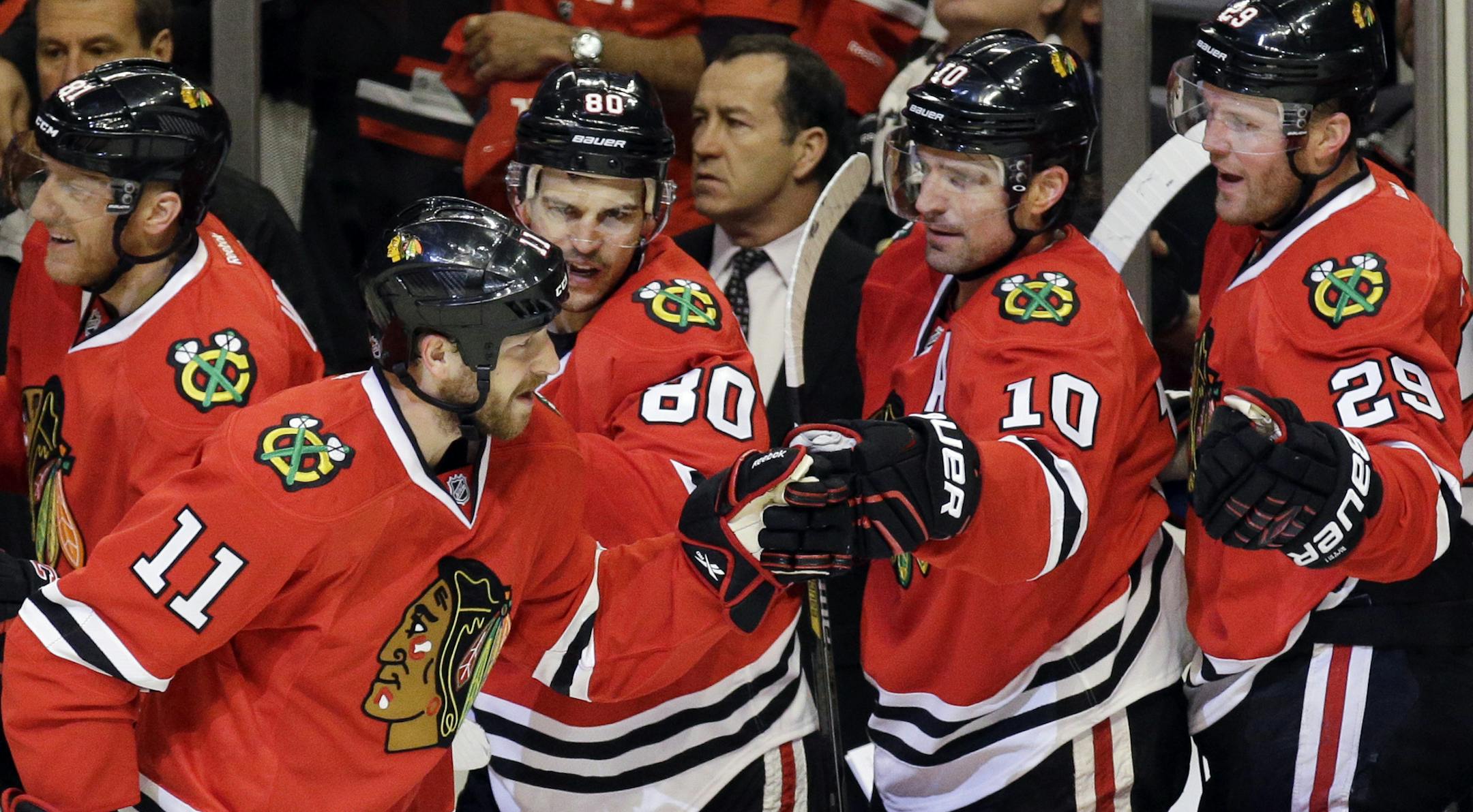 Chicago Blackhawks center Andrew Desjardins (11) celebrates with teammates after scoring his goal during the first period in Game 3 of an NHL Western Conference hockey playoff series against the Nashville Predators Sunday, April 19, 2015, in Chicago. (AP Photo/Nam Y. Huh) ORG XMIT: CXA103