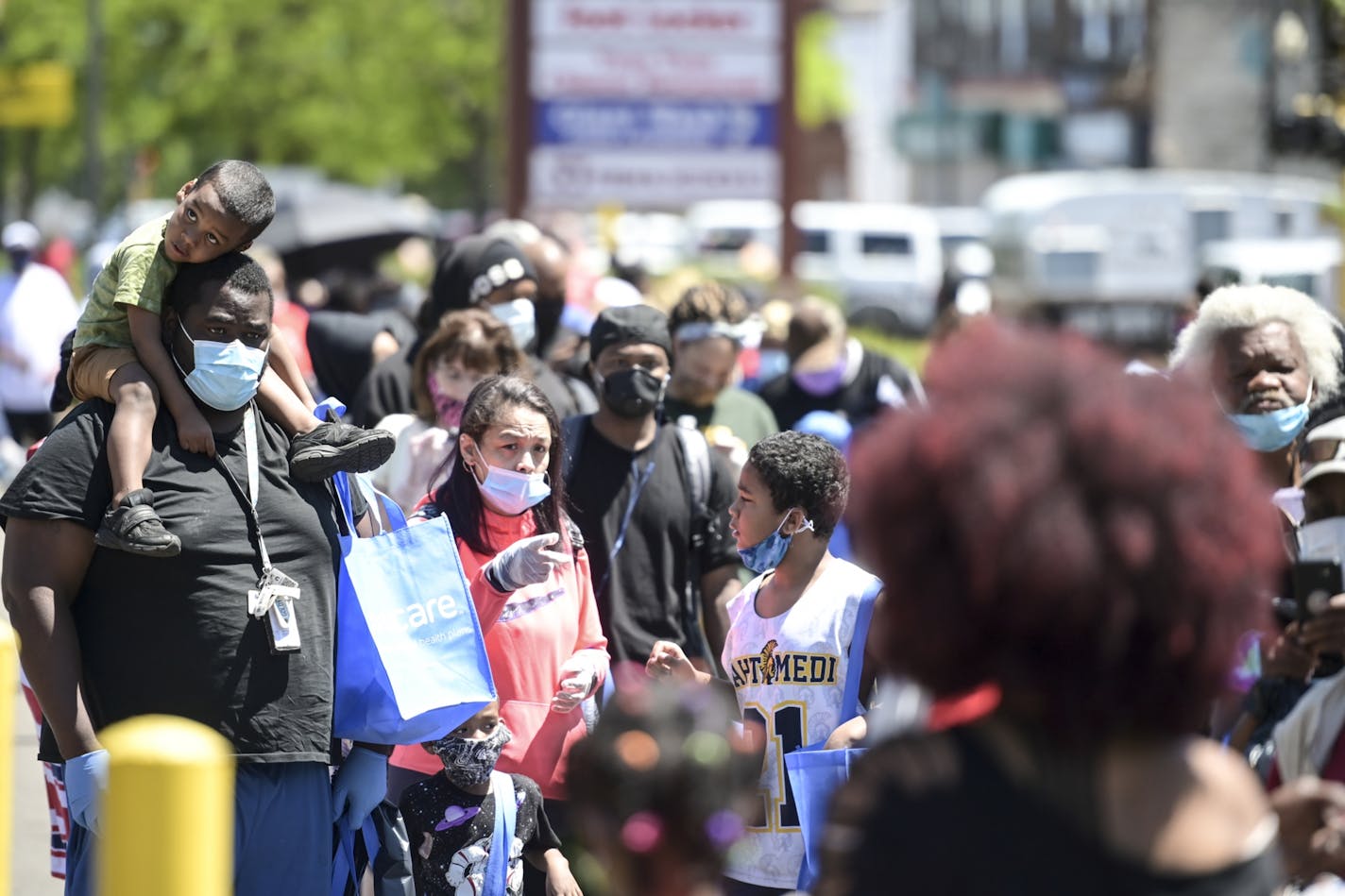 Hundreds of community members waited in line for donated items outside US Bank on West Broadway on Saturday, May 30, 2020 in Minneapolis, Minn.