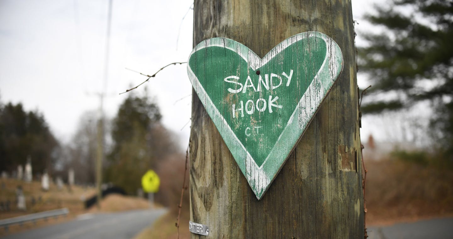 A green, chalkboard-like heart, a small remembrance of the mass shooting at Sandy Hook Elementary, is nailed to a utility pole in Newtown, Conn., Dec. 2, 2017. To see Newtown in 2017, five years after what residents commonly refer to as &#x201c;the tragedy&#x201d; or &#x201c;12/14,&#x201d; is to see how grief endures and evolves and how a community can, however fitfully, negotiate a way forward. (Jessica Hill/The New York Times)