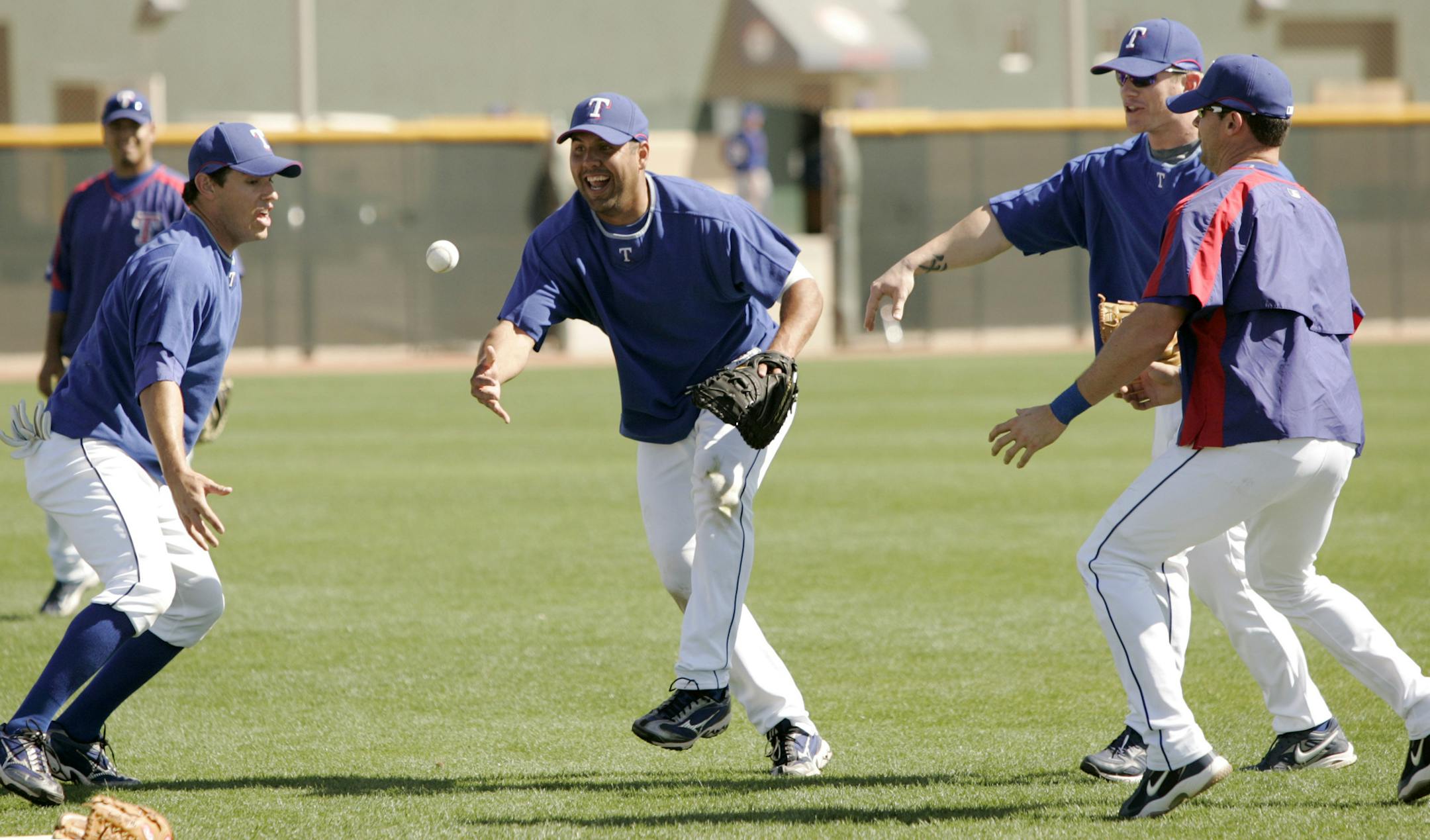 Texas Rangers', from left, Ian Kinsler, Gerald Laird, Hank Blalock and Michael Young share a laugh as they participate in a pepper drill during morning practice at baseball spring training in Surprise, Ariz., Tuesday, March 13, 2007. (AP Photo/Tony Gutierrez) ORG XMIT: AZTG115