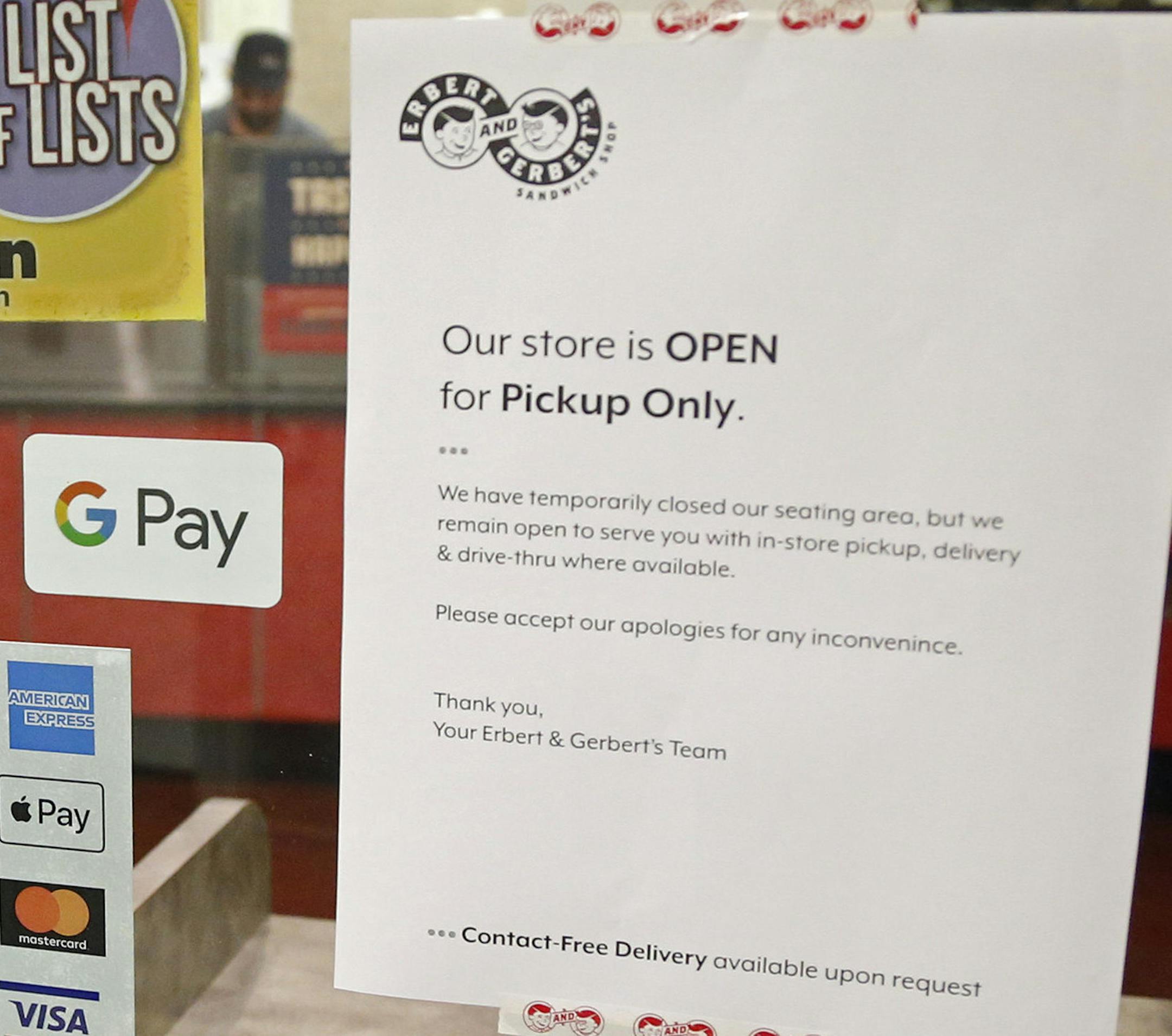 A downtown Minneapolis eatery displays the "Pickup Only" sign at the entrance Wednesday, March 18, 2020. No indoor seating is allowed in restaurants due to the coronavirus. (AP Photo/Jim Mone)