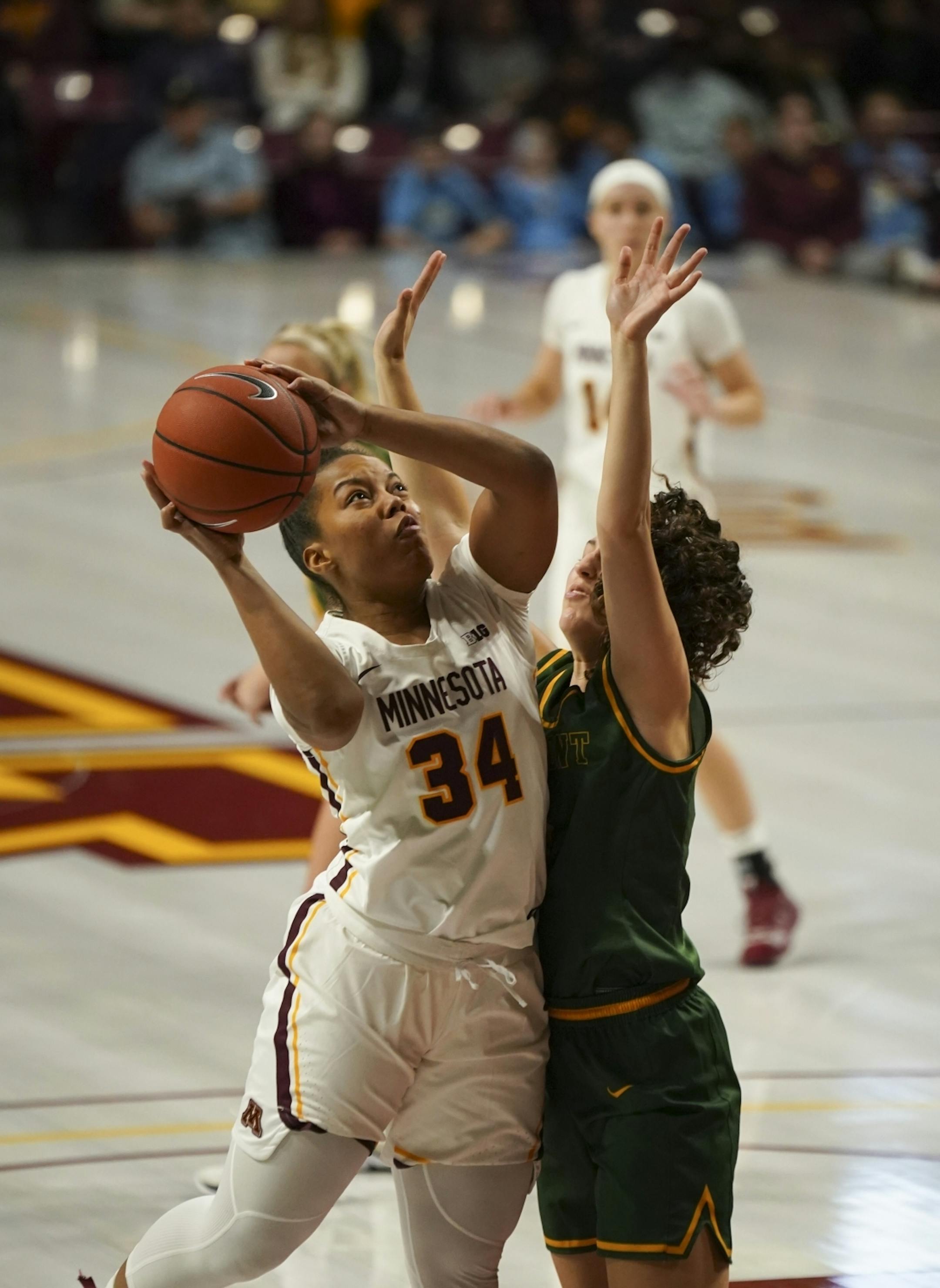 Minnesota Golden Gophers guard Gadiva Hubbard (34) shot in the second quarter against the defense of Vermont Catamounts guard Josie Larkins (5).