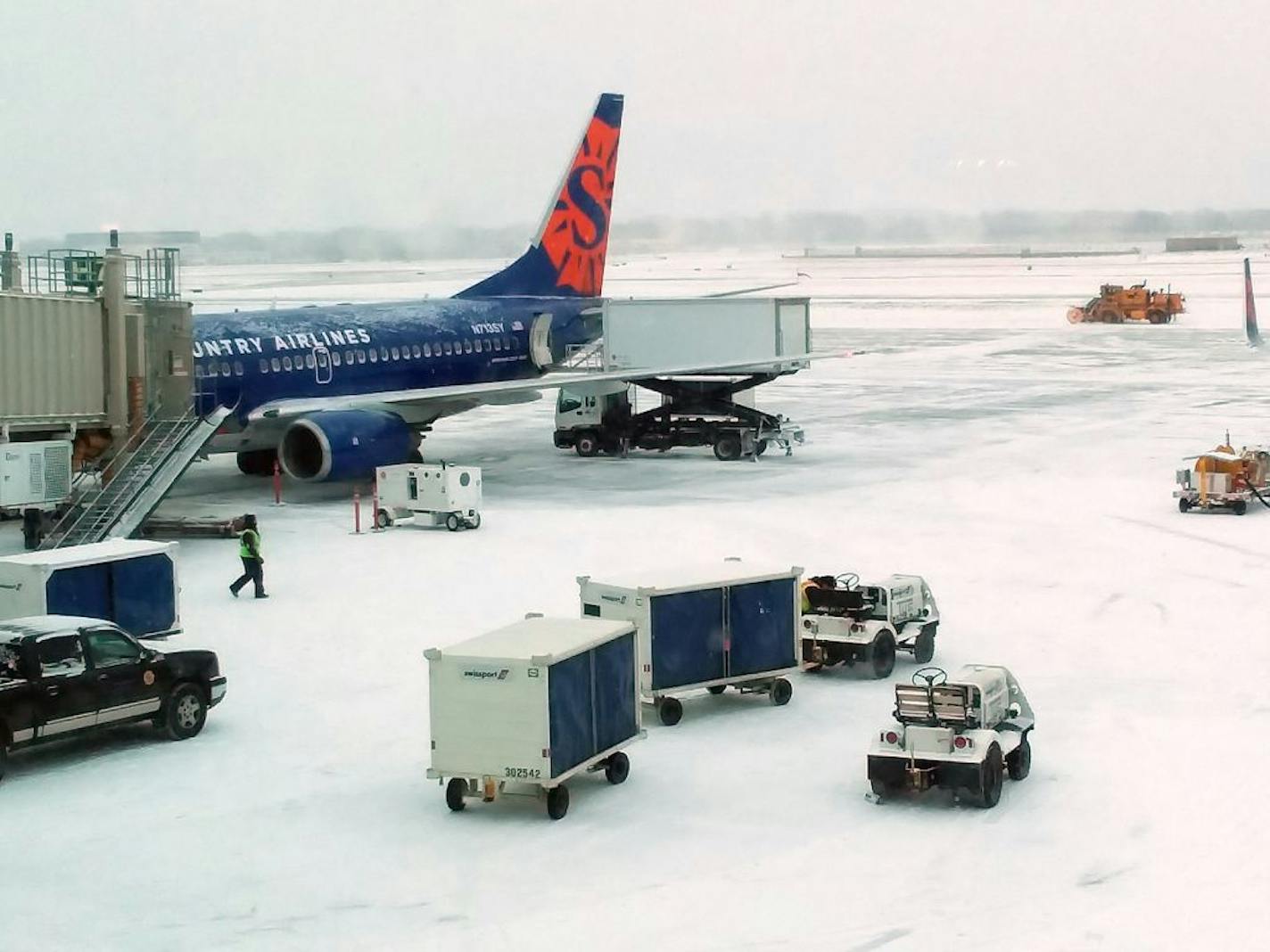 File photo: A Sun Country flight at the gate at Terminal 2 during a winter storm.