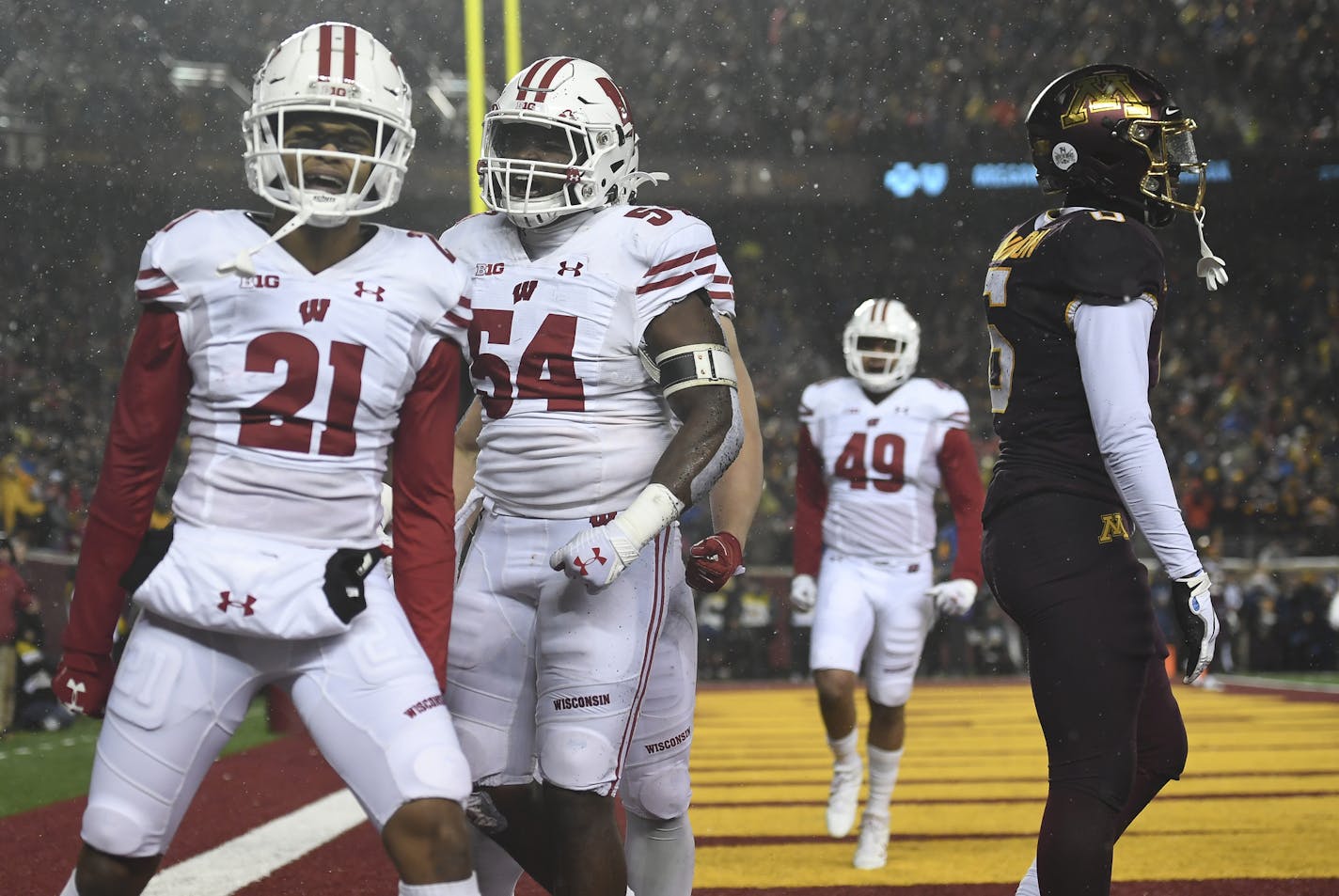 Wisconsin cornerback Caesar Williams (21) and linebacker Chris Orr (54) celebrated after Williams broke up a pass intended for Gophers wide receiver Tyler Johnson in the second half.