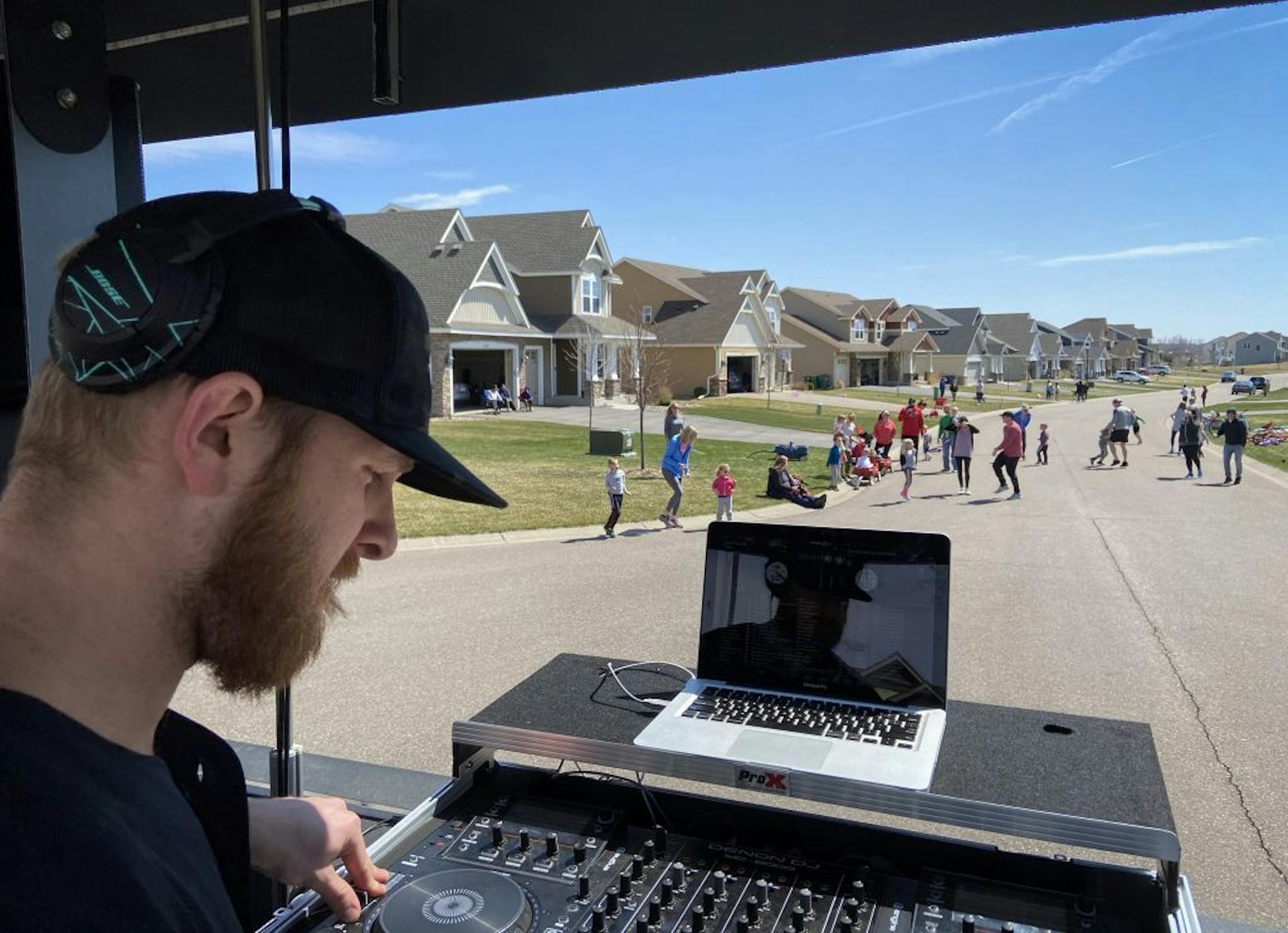 DJ Lemonhead (Joe Masek) of St. Paul brought his high end music DJ truck to a neighborhood in Lakeville, Minn. for a Social Distancing Dance Party. Masek, as part of Impact Entertainment, has been traveling around the Twin Cities "sharing love, joy and a message of hope with people. We know this is a crazy time, and if we weren't doing this for free with the truck, the truck would be just sitting in the backyard." "We're doing this until the quarantine is over," Masek said. "We're going to keep