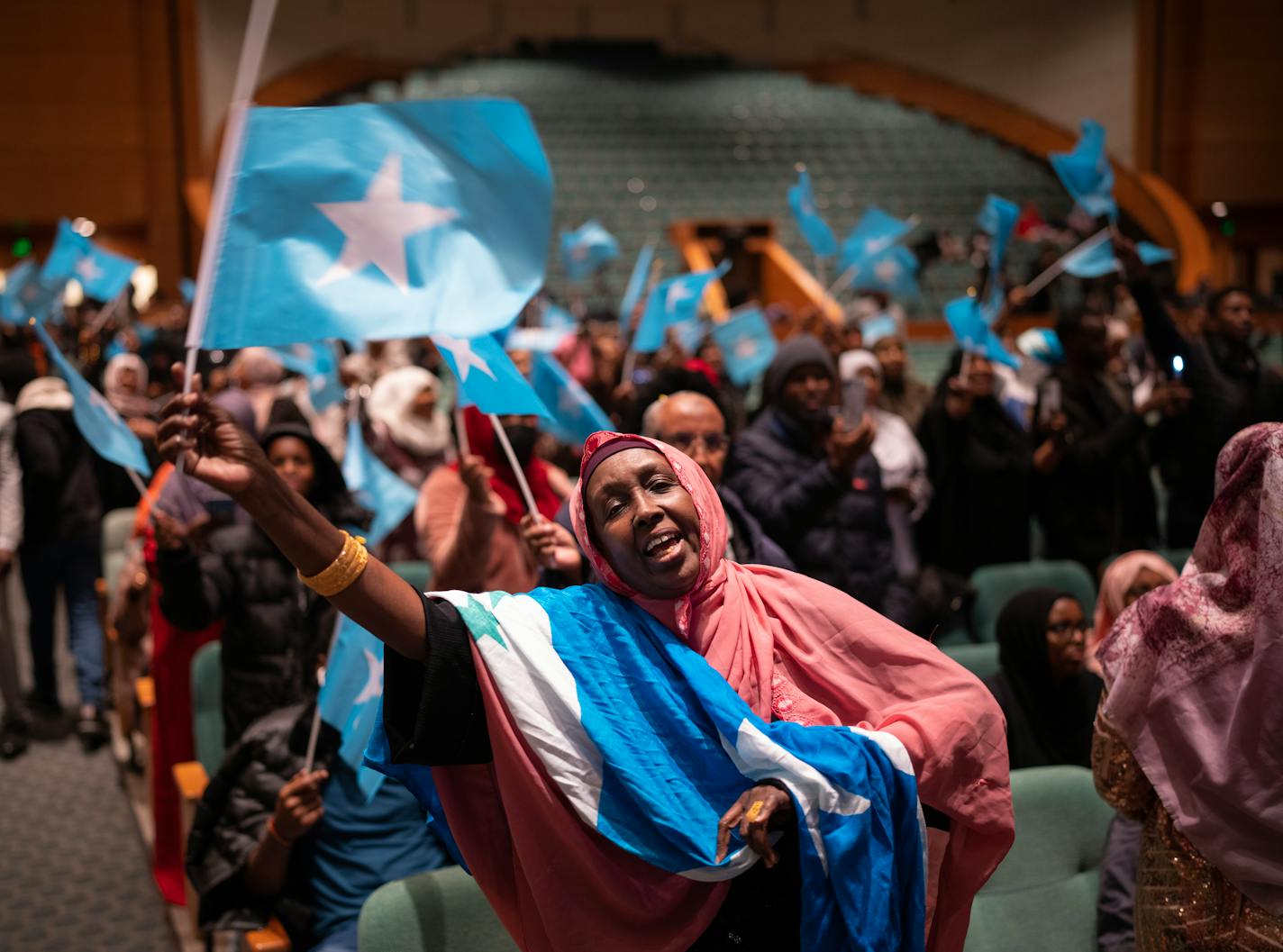 Sawo Kwao sang and waved the Somali flag Thursday night, December 15, 2022 as a DJ played Somali pop music for the crowd in the auditorium of the Minneapolis Convention Center awaiting the arrival of Somali President Hassan Sheikh Mohamud. Somali President Hassan Sheikh Mohamud is in town to address the members of the Somali community, the largest outside Africa, after attending the U.S. - Africa Leaders Summit in Washington, D.C. this week. ] JEFF WHEELER • jeff.wheeler@startribune.com