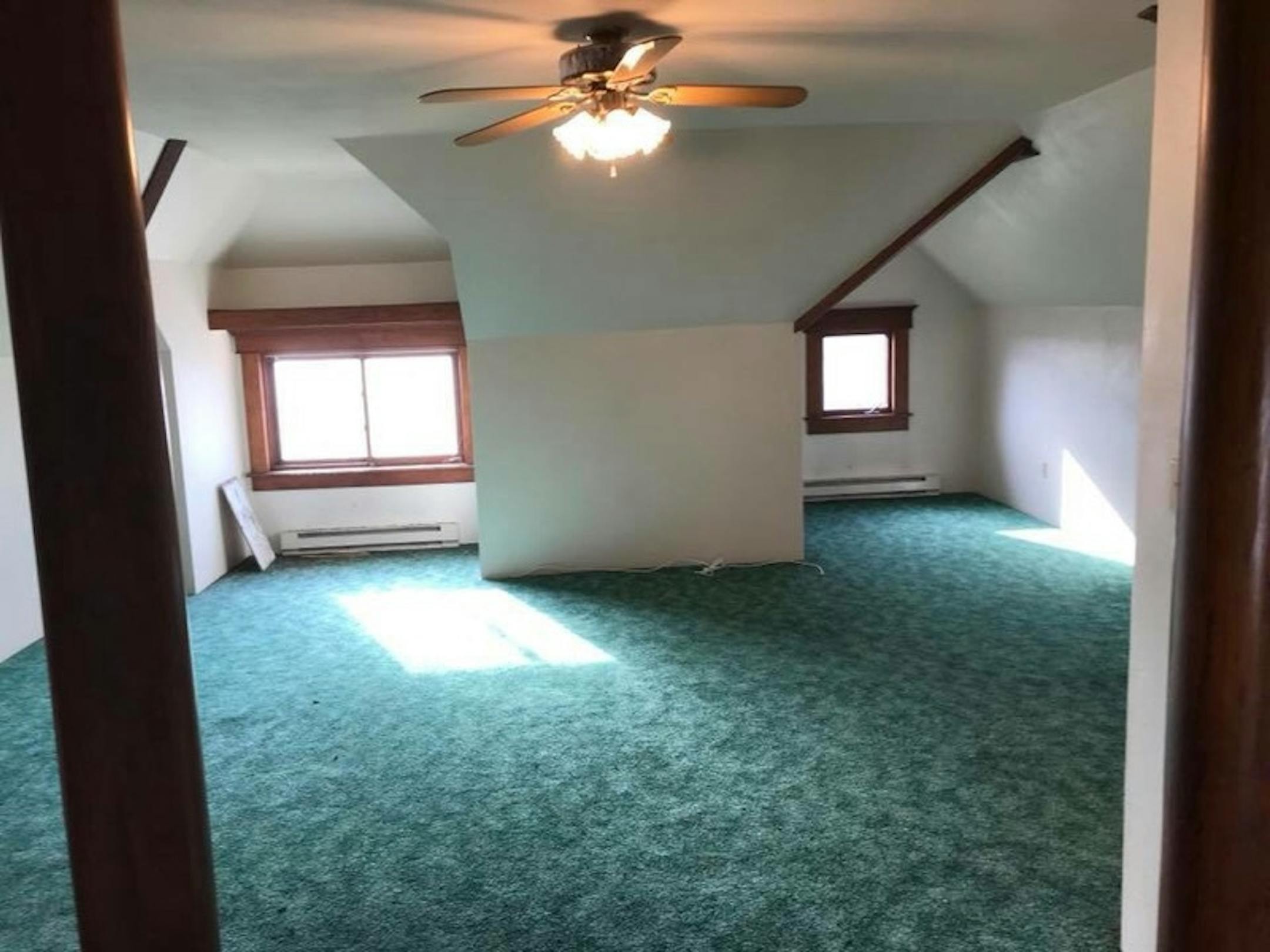 This Iowa farmhouse's owners restored the woodwork to its early 20th-century grandeur. They offered the house for free on Craigslist, and found a Minnesota taker. Courtesy Roger Dolecheck