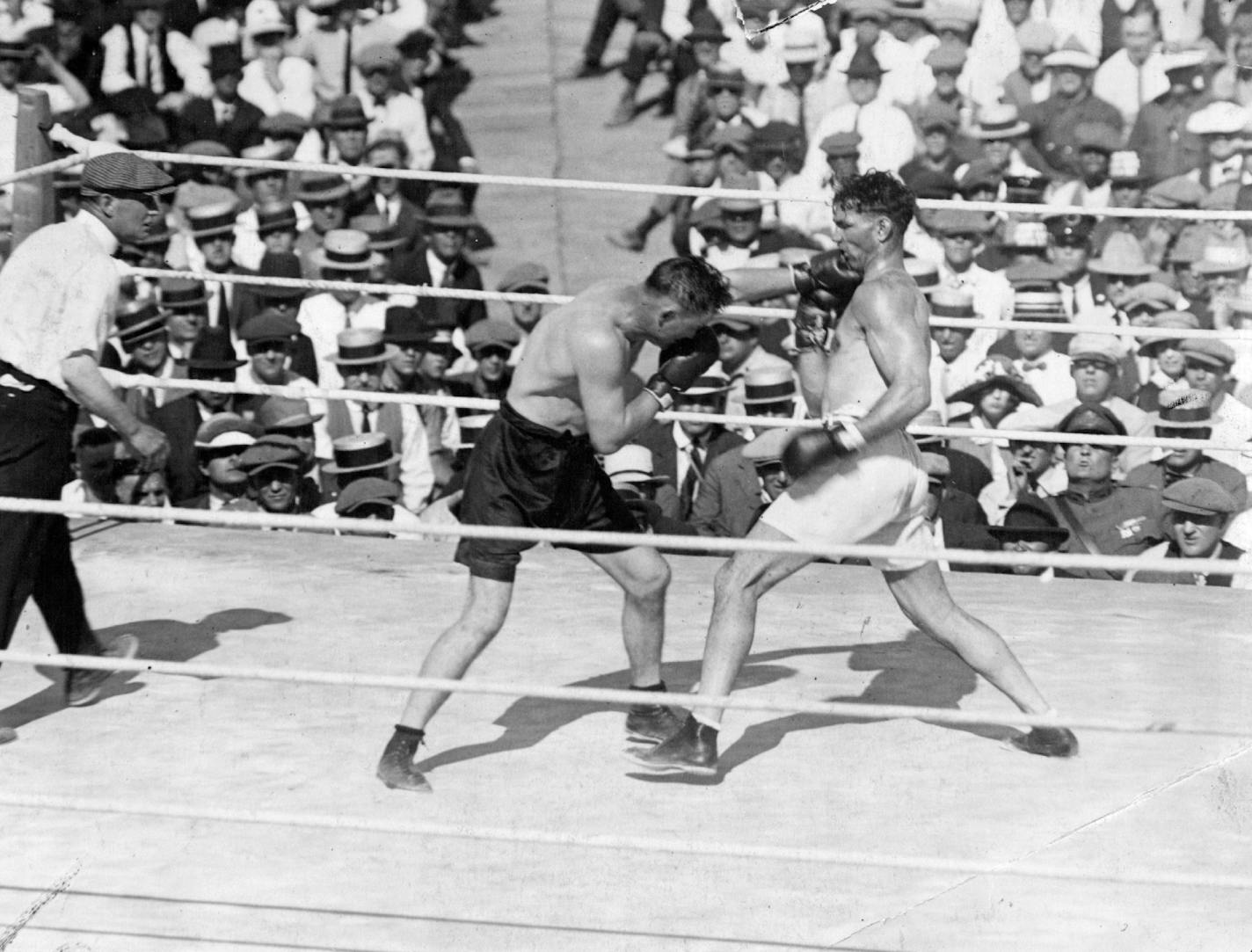 June 29, 1980 Jack Dempsey, left, and Tommy Gibbons of St. Paul touched gloves before their heavyweight championship fight on July 4, 1923, at Shelby, Mont. Above, Gibbons landed a left to the champ's chin in the open-air ring. Jack Dougherty was the referee. ORG XMIT: MIN2017012708023480