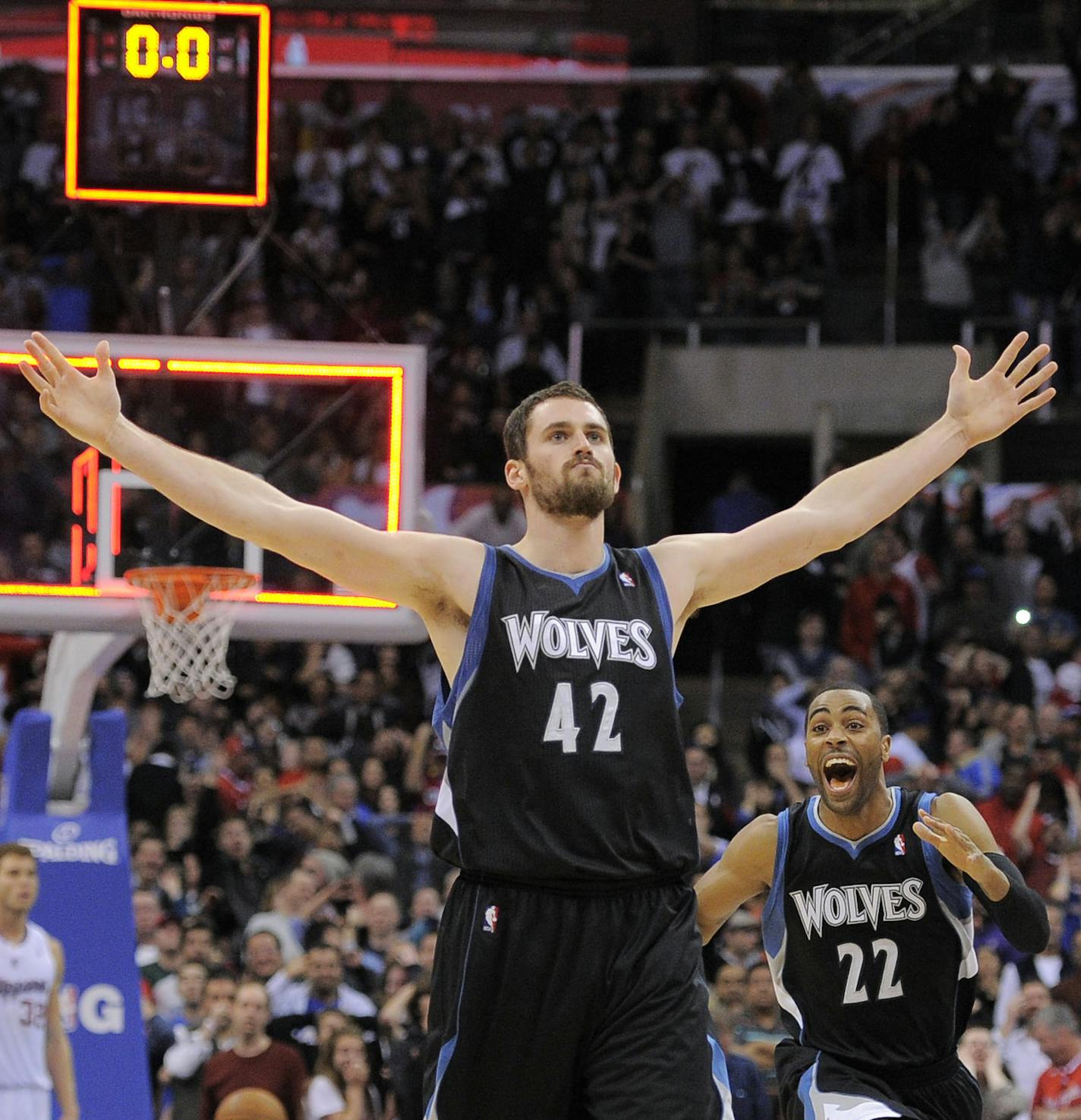 Minnesota Timberwolves forward Kevin Love (42) reacts with guard Wayne Ellington (22) after hitting a three point shot to win the game during the second half of their NBA basketball game against the Los Angeles Clippers, Friday, Jan. 20, 2012, in Los Angeles. The Timberwolves won 101-98. (AP Photo/Mark J. Terrill) ORG XMIT: LAS107