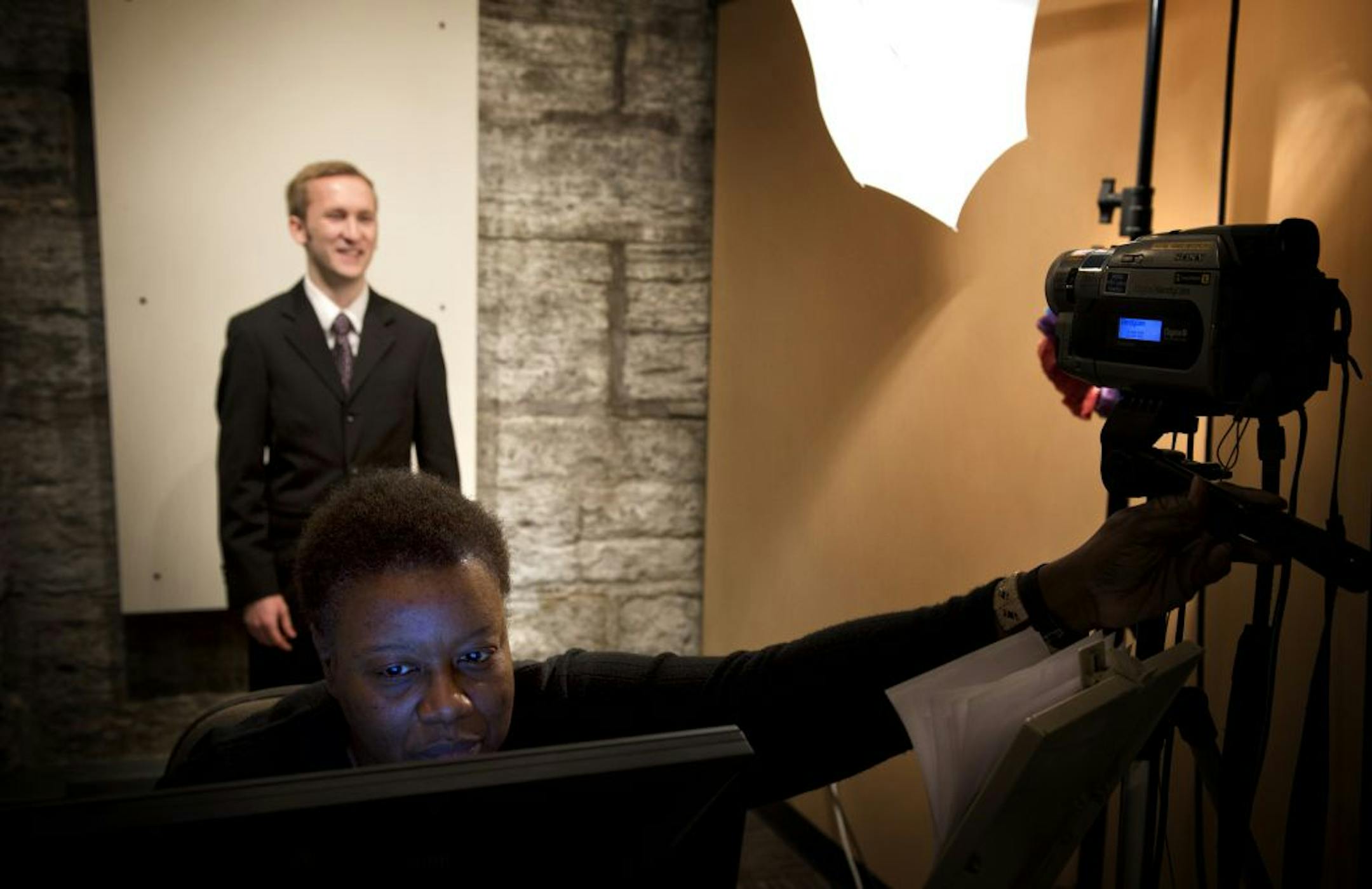 Gloria Edwards is used to the opening day rush at the Capitol, and as she has for 12 years, she expects to process hundreds of new credentials for legislators and staff. Here, she adjusted her camera Monday for Bryan Wells, legislative assistant to Sen. Kevin Dahle.