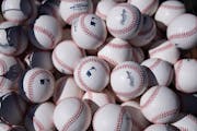 Baseballs sit in a pile for batting practice before the Twins home opener at Target Field in Minneapolis on Thursday.