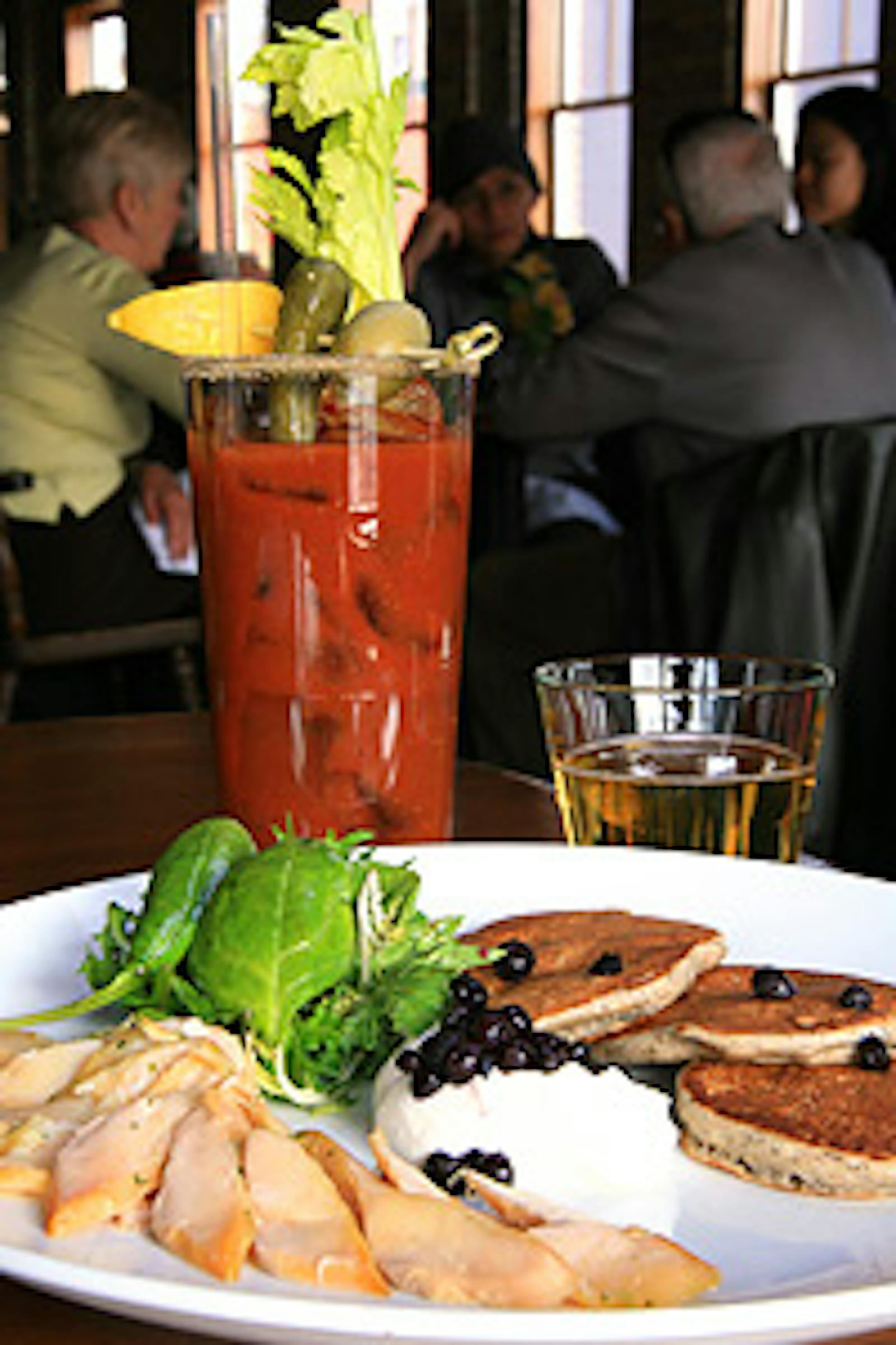 Red Stag Supperclub's smoked lake trout with huckleberries, whole wheat "flapjacks" and greens.