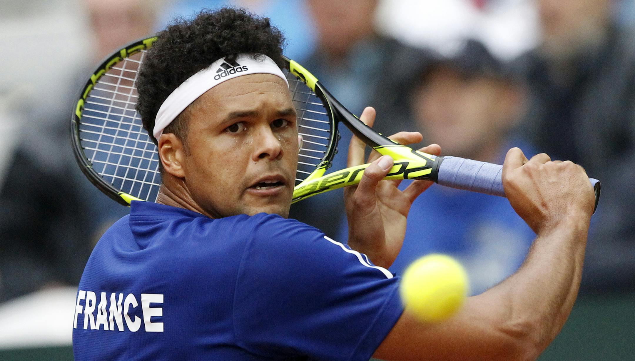 Wilfried Tsonga of France returns the ball to Laslo Djere of Serbia during their Davis Cup semi final at the Pierre Mauroy stadium in Lille, northern France, Friday, Sept.15, 2017. (AP Photo/Michel Spingler)