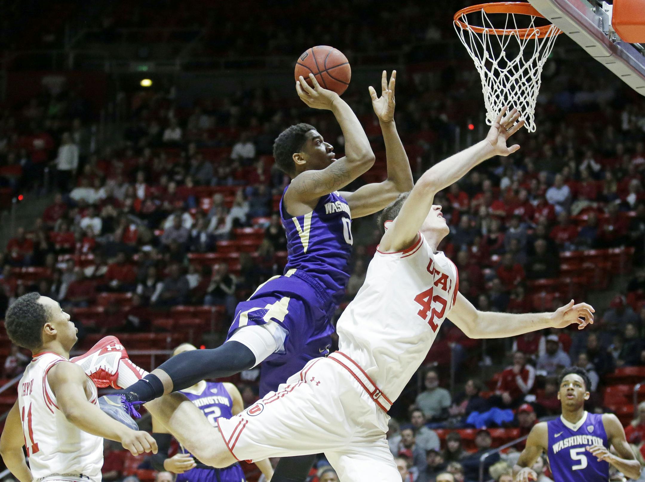 Washington forward Marquese Chriss (0) goes to the basket as Utah forward Jakob Poeltl (42) defends in the first half during an NCAA college basketball game Wednesday, Feb. 10, 2016, in Salt Lake City. (AP Photo/Rick Bowmer) ORG XMIT: UTRB102