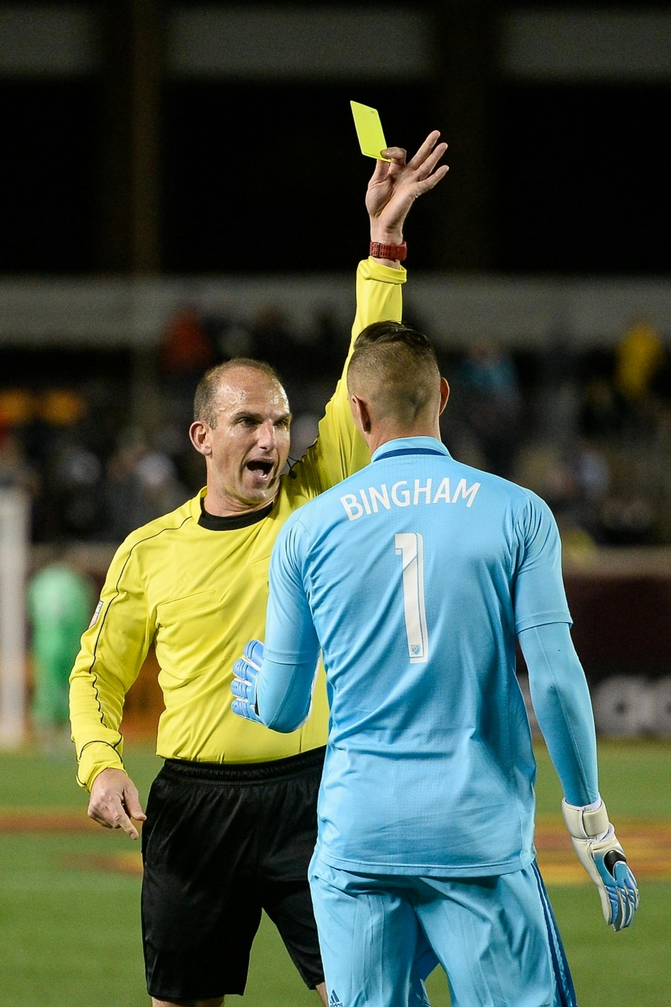 An official penalized San Jose Earthquakes goalkeeper David Bingham (1) with a yellow card late in the second half Saturday.