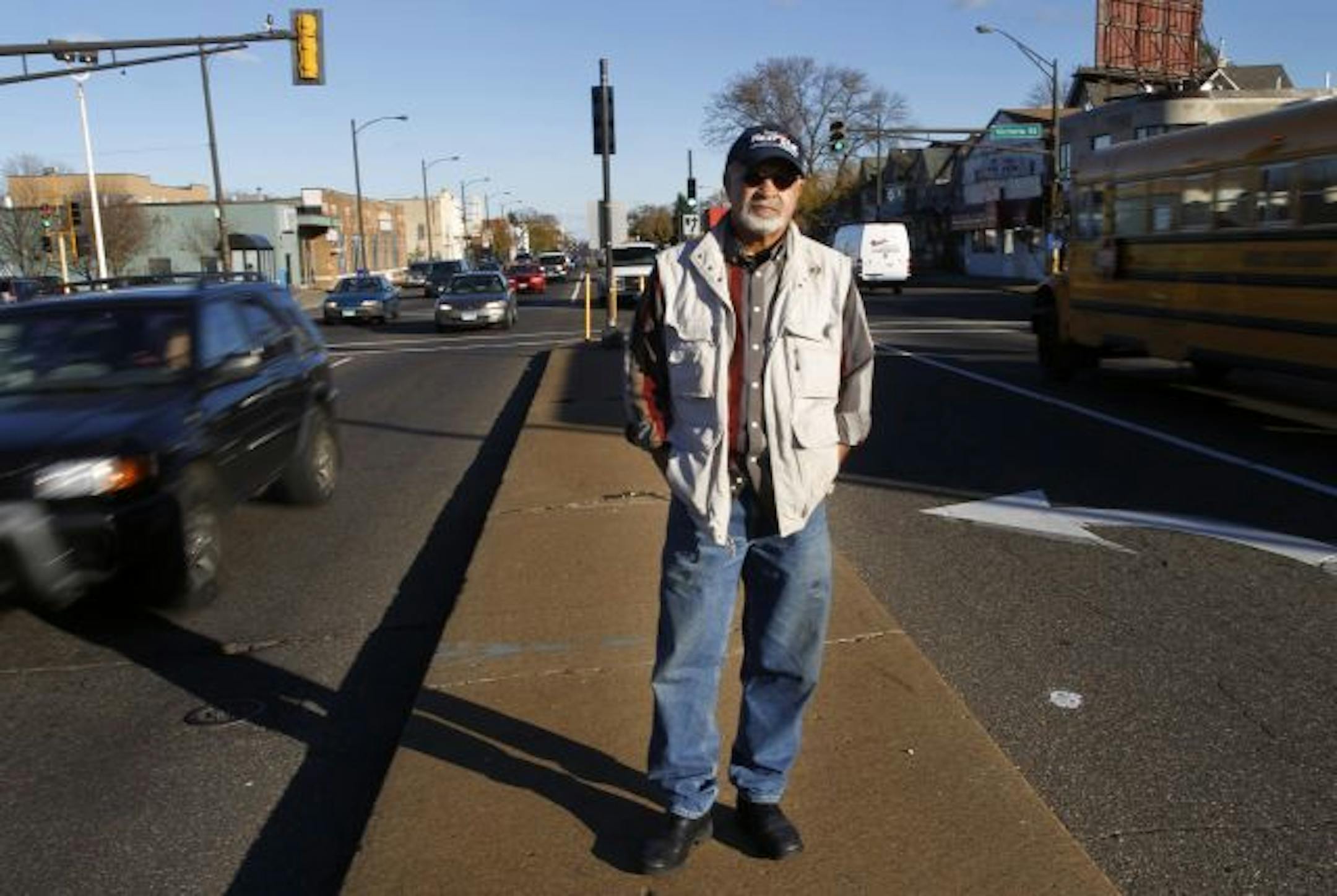 Nick Khaliq, standing on University Avenue, has been active in demanding the extra stops on the lightrail line to St. Paul to better serve the residents along the avenue.