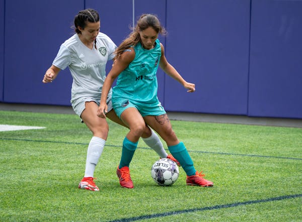 Minnesota Aurora midfielder Mariah Nguyen (front) battled for possession last Sunday in the semifinals against McLean Soccer at TCO Stadium.