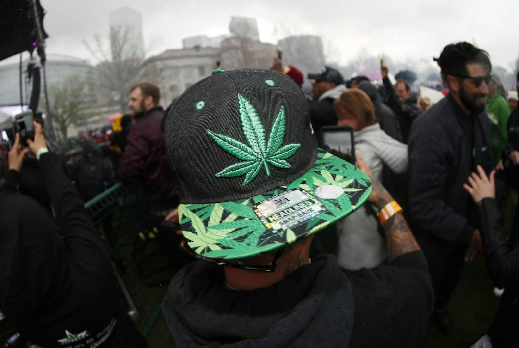 An attendee celebrates at 4:20 p.m. by lighting up marijuana during the Mile High 420 Festival Friday, April 20, 2018, in Denver. The annual celebration was projected to attract an estimated 50,000 people in Civic Center Park.