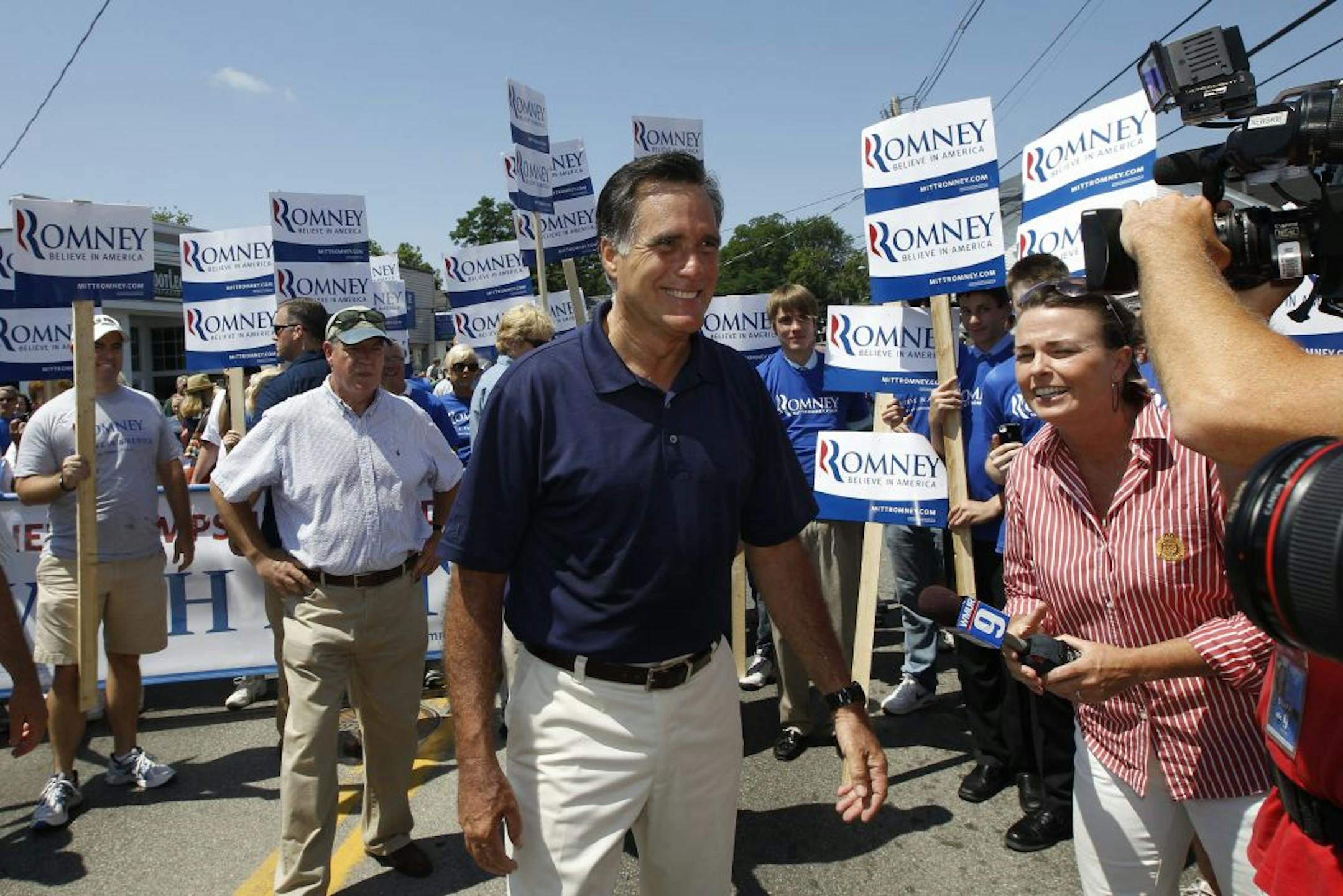 Mitt Romney walks in the Fourth of July Parade in Wolfeboro, N.H., Wednesday, July 4, 2012.