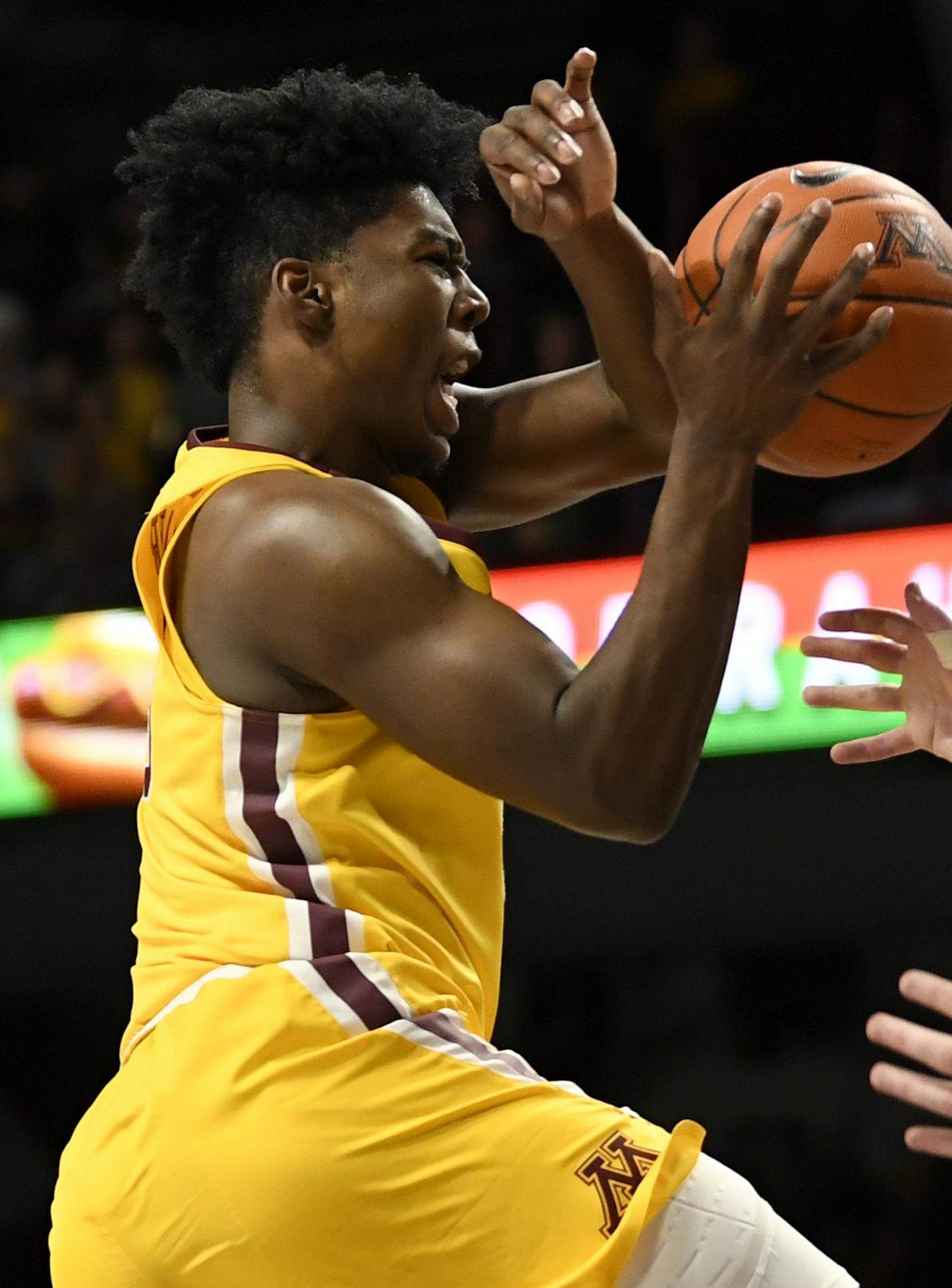 Minnesota's Marcus Carr, left, loses the ball against Michigan's Jon Teske (15) in the first half during an NCAA college basketball game on Sunday, Jan. 12, 2020, in Minneapolis. (AP Photo/Hannah Foslien)