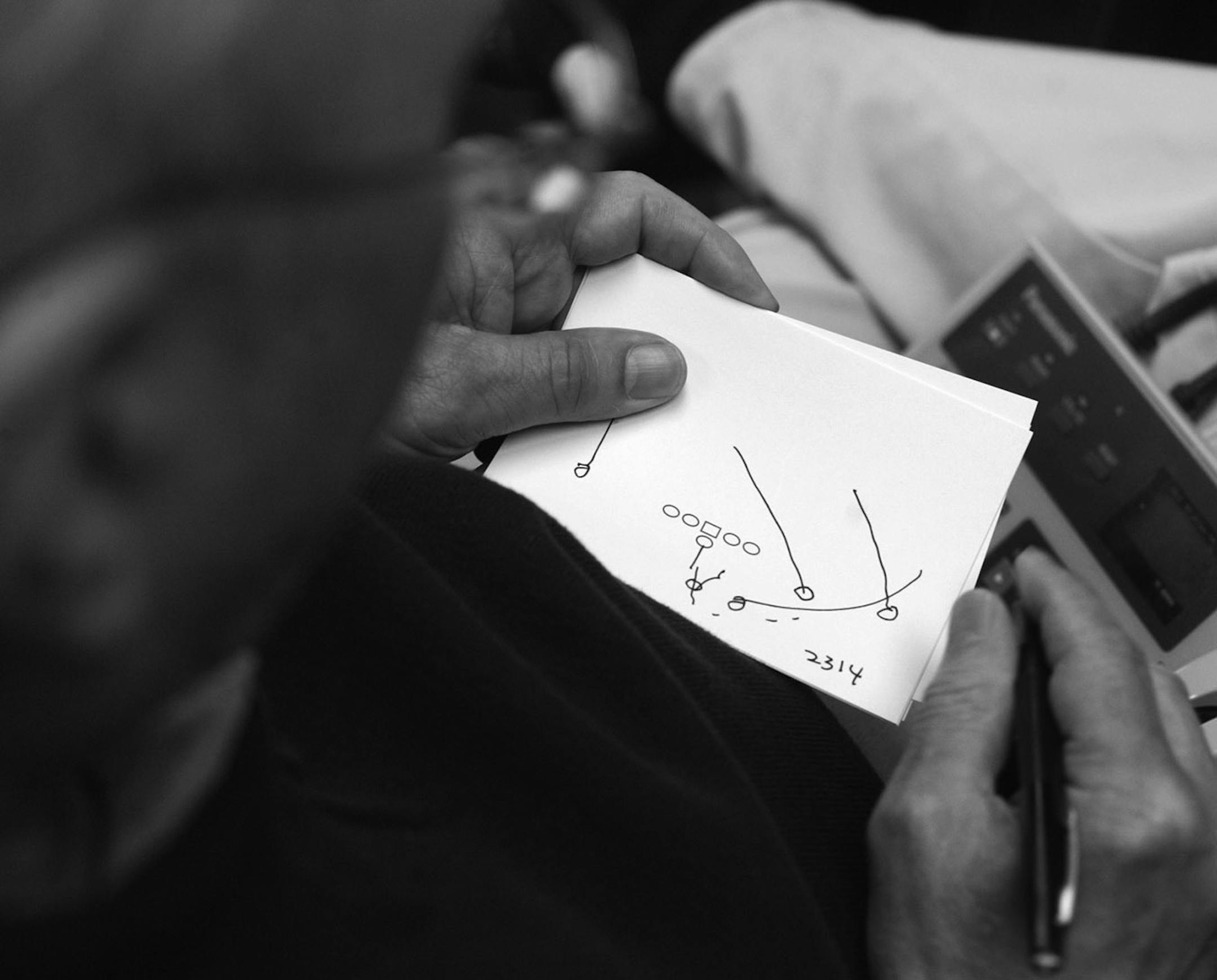 Before an October 2003 practice, St. John's coach John Gagliardi went over plays he had drawn up.