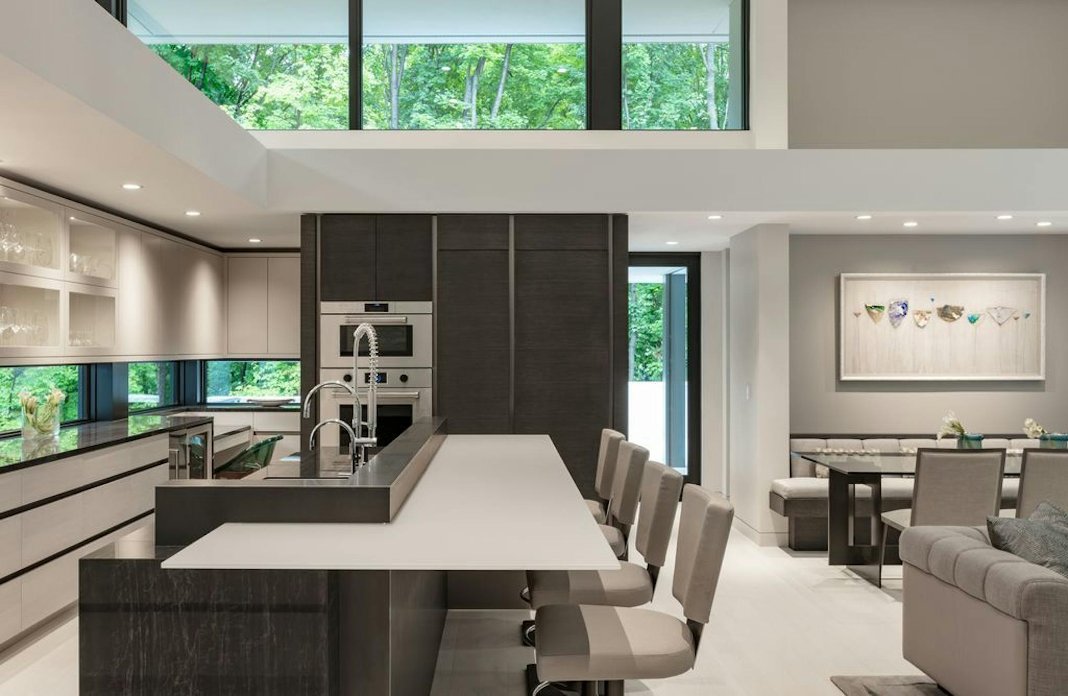 The island is composed of three materials including a back-painted glass top to give it an airy quality.