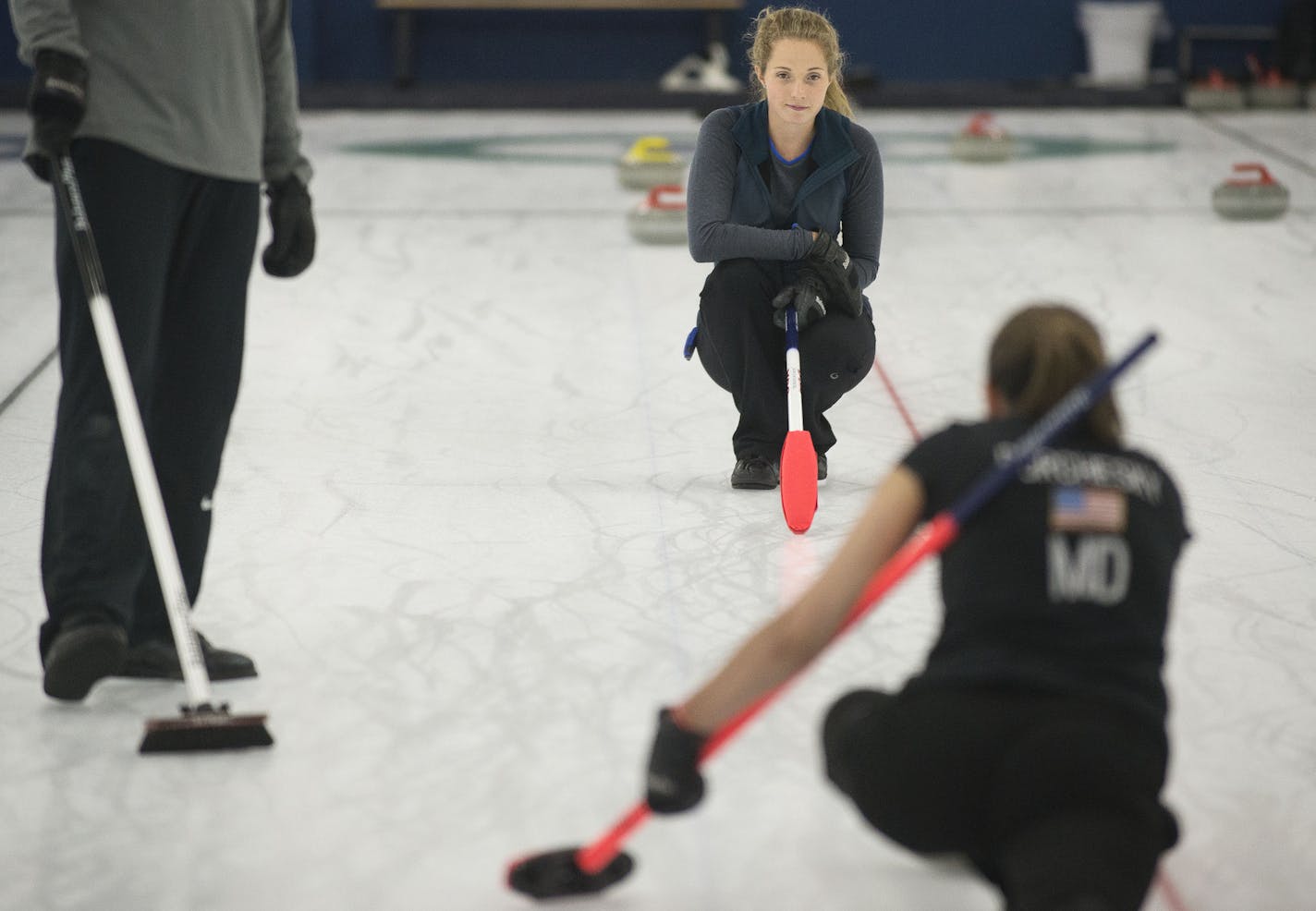 Sarah Anderson, center, of Minneapolis, watched with Jared Zezel, of Hibbing, a curler from the 2014 Olympic team, as Jenna Burchesky, of Eau Claire, practiced her curling form at the Four Seasons Curling Club in Blaine Minn. on Friday August 14, 2015. ] RACHEL WOOLF &#xb7; rachel.woolf@startribune.com The Anderson twins moved to Minneapolis while they attend the University of Minnesota to be close to the Four Seasons Curling Club.