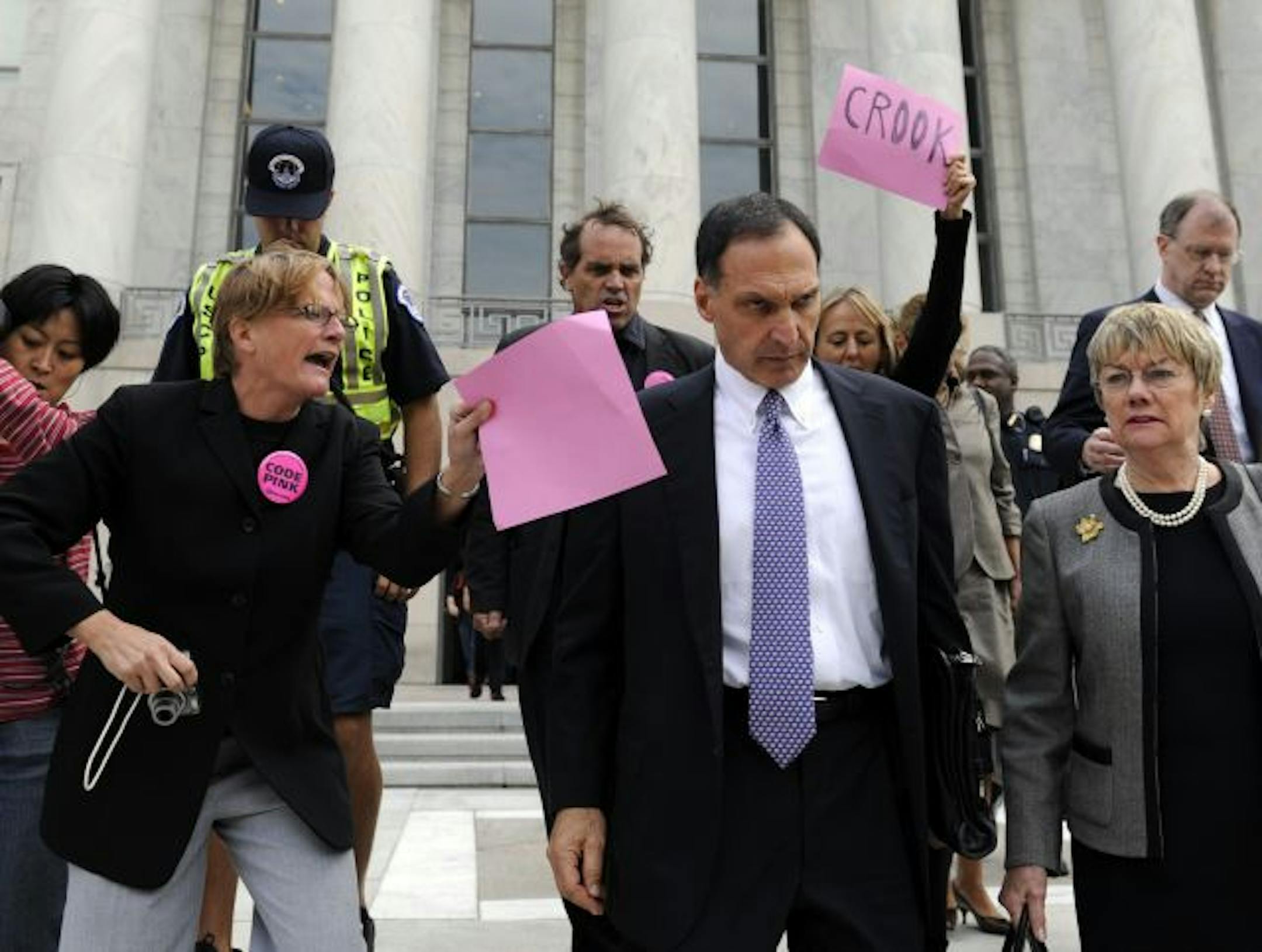 FILE - In this Oct. 6, 2008 file photo, Lehman Brothers Holdings Inc. Chief Executive Richard S. Fuld Jr., front center, is heckled by protesters as he leaves Capitol Hill in Washington after testify before the House Oversight and Government Reform Committee on the collapse of Lehman Brothers.