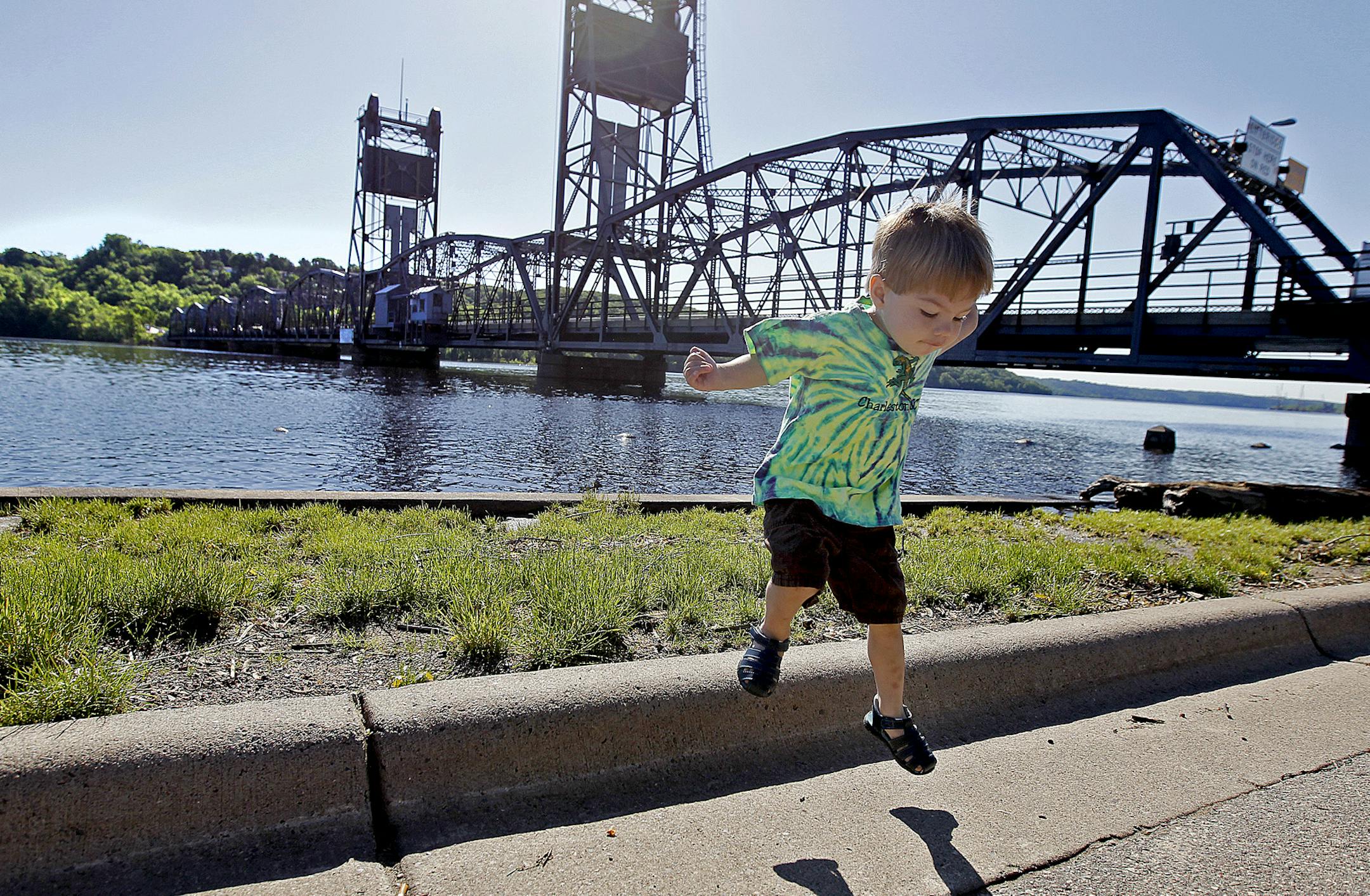 Ben Slagle, 2, and his mother Desiree Slagle took a stroll along the St. Croix River as the Minnesota Department of Transportation workers worked on the Stillwater Lift Bridge over the St. Croix River, Monday, June 17, 2013 in Stillwater, MN. It is blocking boat traffic until a snapped cable can be repaired. The Minnesota Department of Transportation reported Sunday night that it’s not known when the bridge lift will reopen. The bridge remains open for motor vehicles. (ELIZABETH FLORES/ST